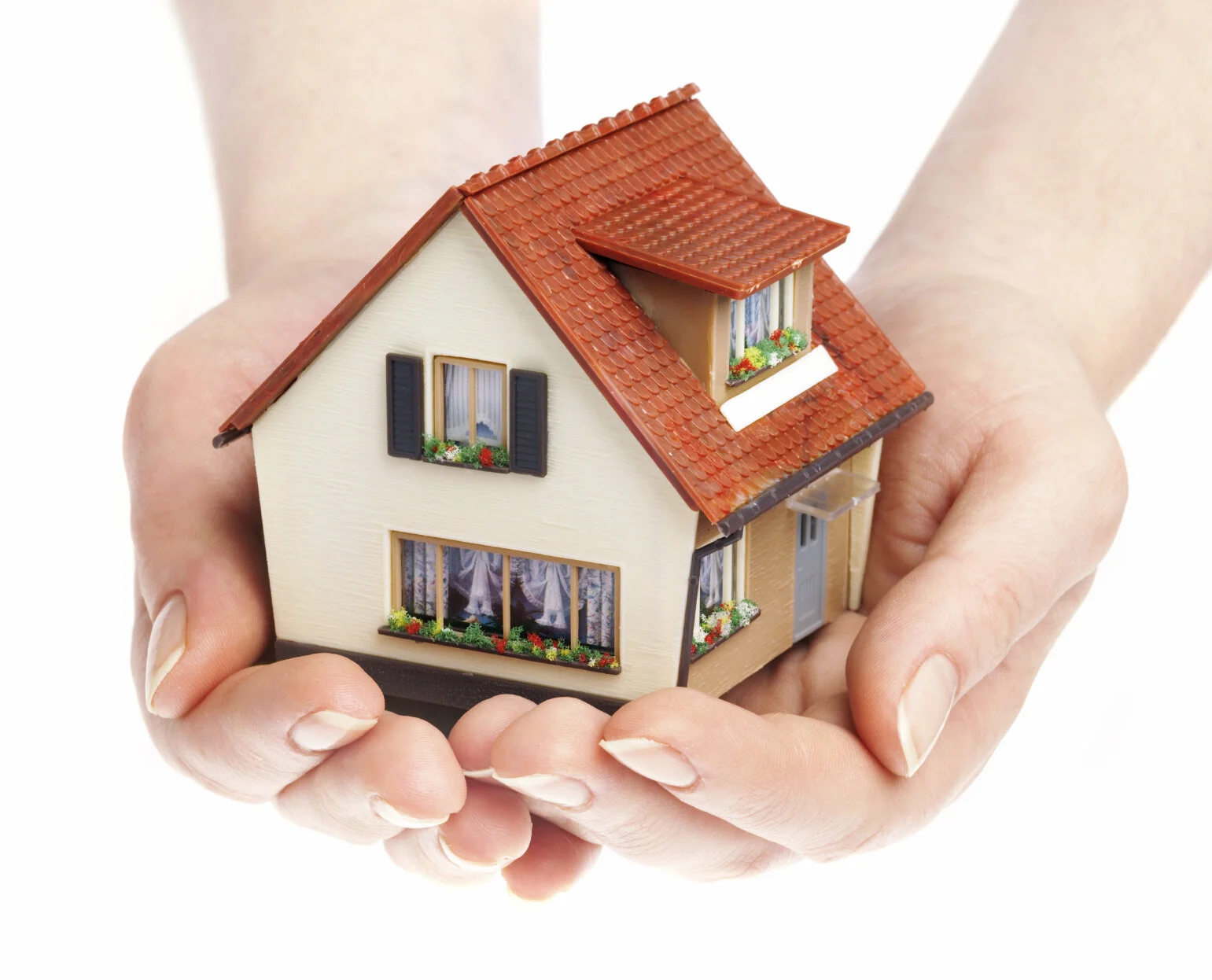 Two hands holding a small model house