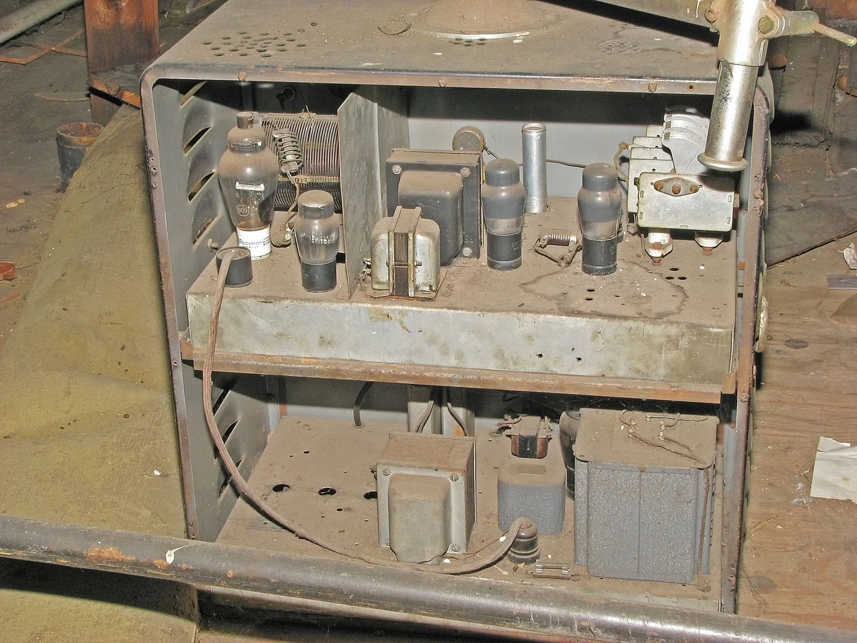 Inside view of "Low" device's circuitry, as originally found in Mr. Low's attic. Prior-drilled empty holes in the chassis indicate the cabinet housed an earlier design.