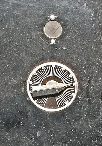 "Low" device closeup of amplitude dial for adjustment of modulation depth (strength). Above it, the empty round circular location likely held an old "magic eye" for visual confirmation of the correct radio carrier frequency. The RCA magic eye was onl