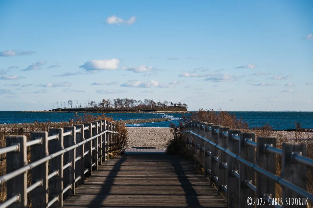 Boardwalk at Silver Sands State Park leading to view of Charles Island across the water.