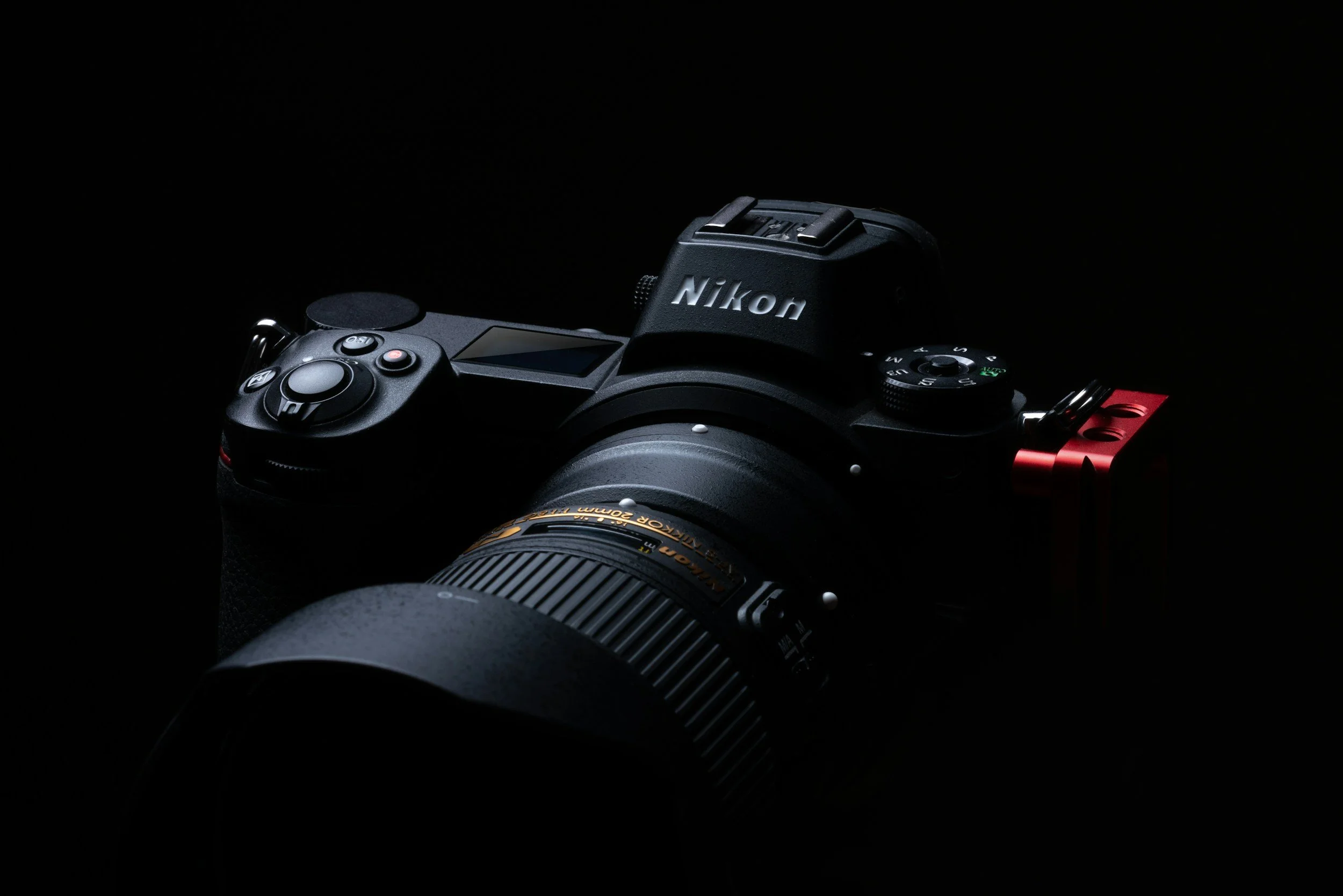 Stock photo of a nikon camera body and lens.