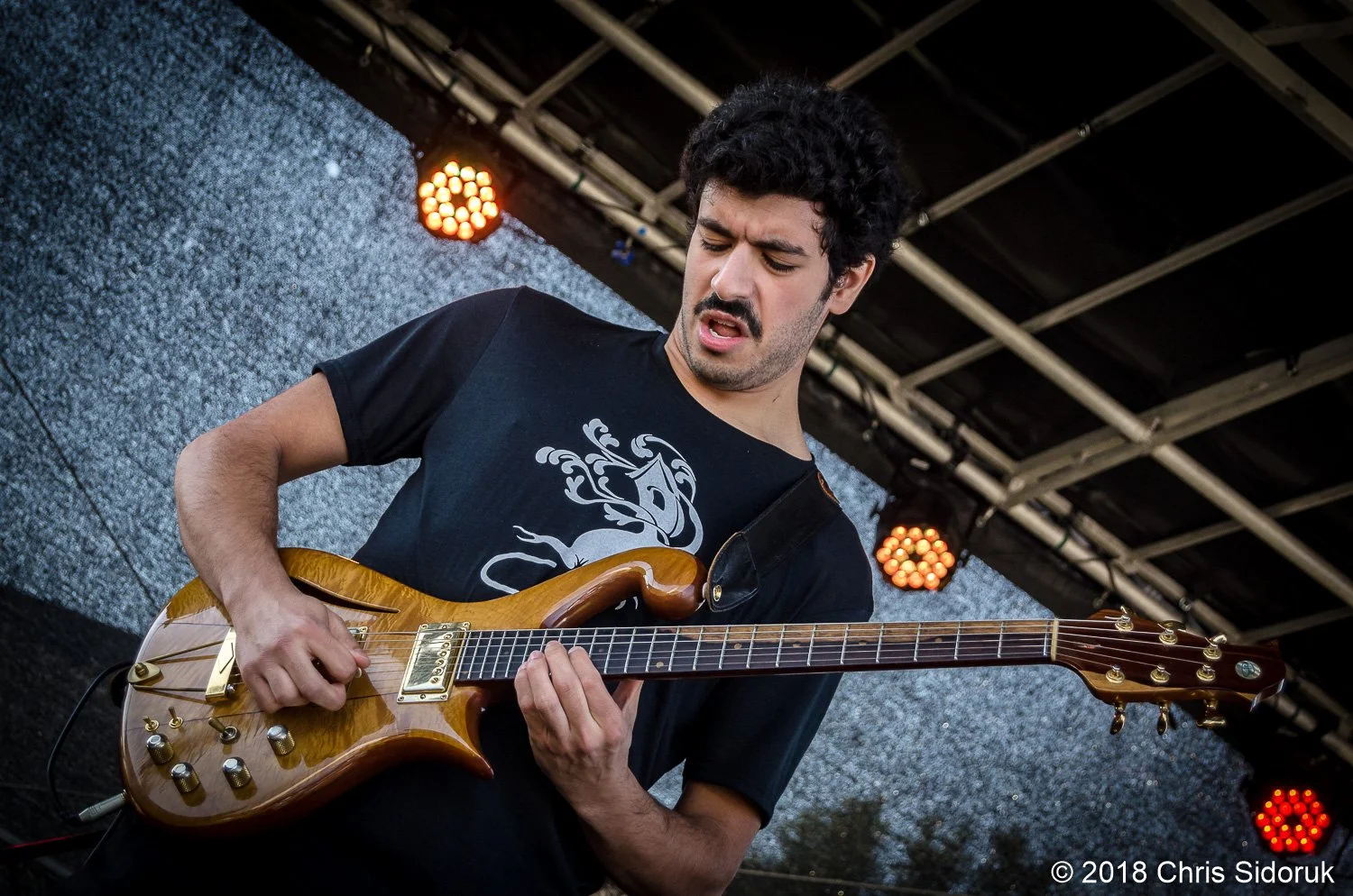 Eggy guitarist performing live during a fall outdoor concert