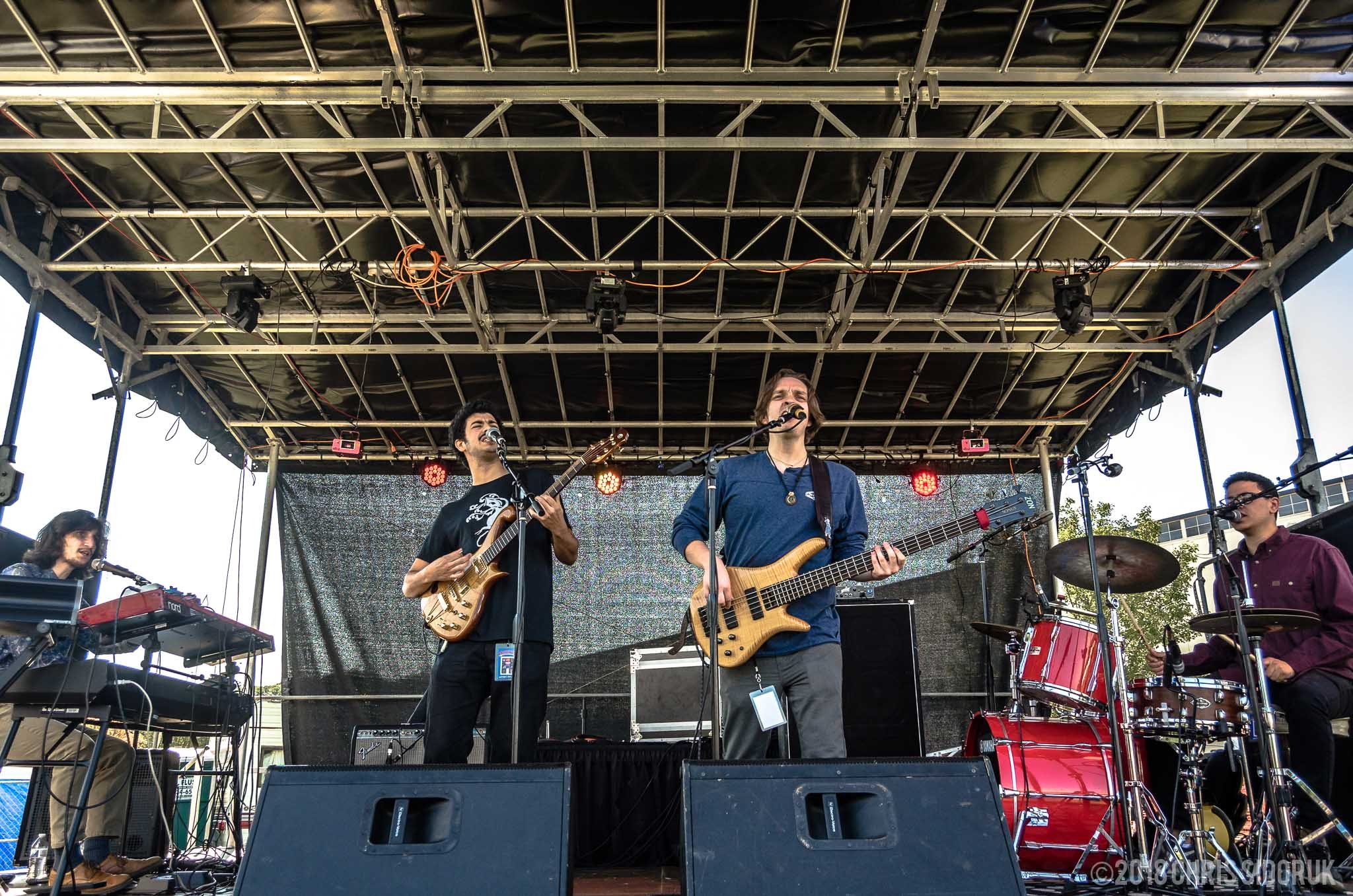 Eggy performing live with full band on stage during a live music show