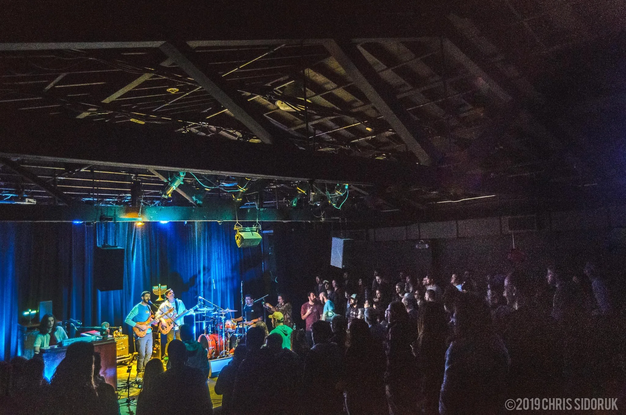 Eggy performing live in front of a packed crowd during a concert