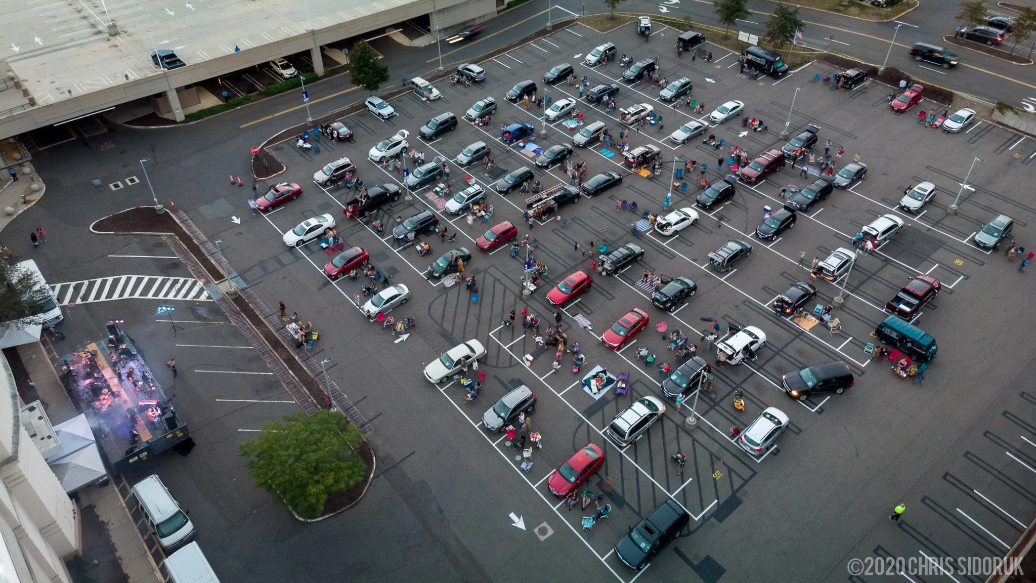 Creamery Station performing live at The Drive In at Connecticut Post Mall in Milford, Connecticut, on September 27, 2020, with outdoor stage setup and audience vehicles visible.