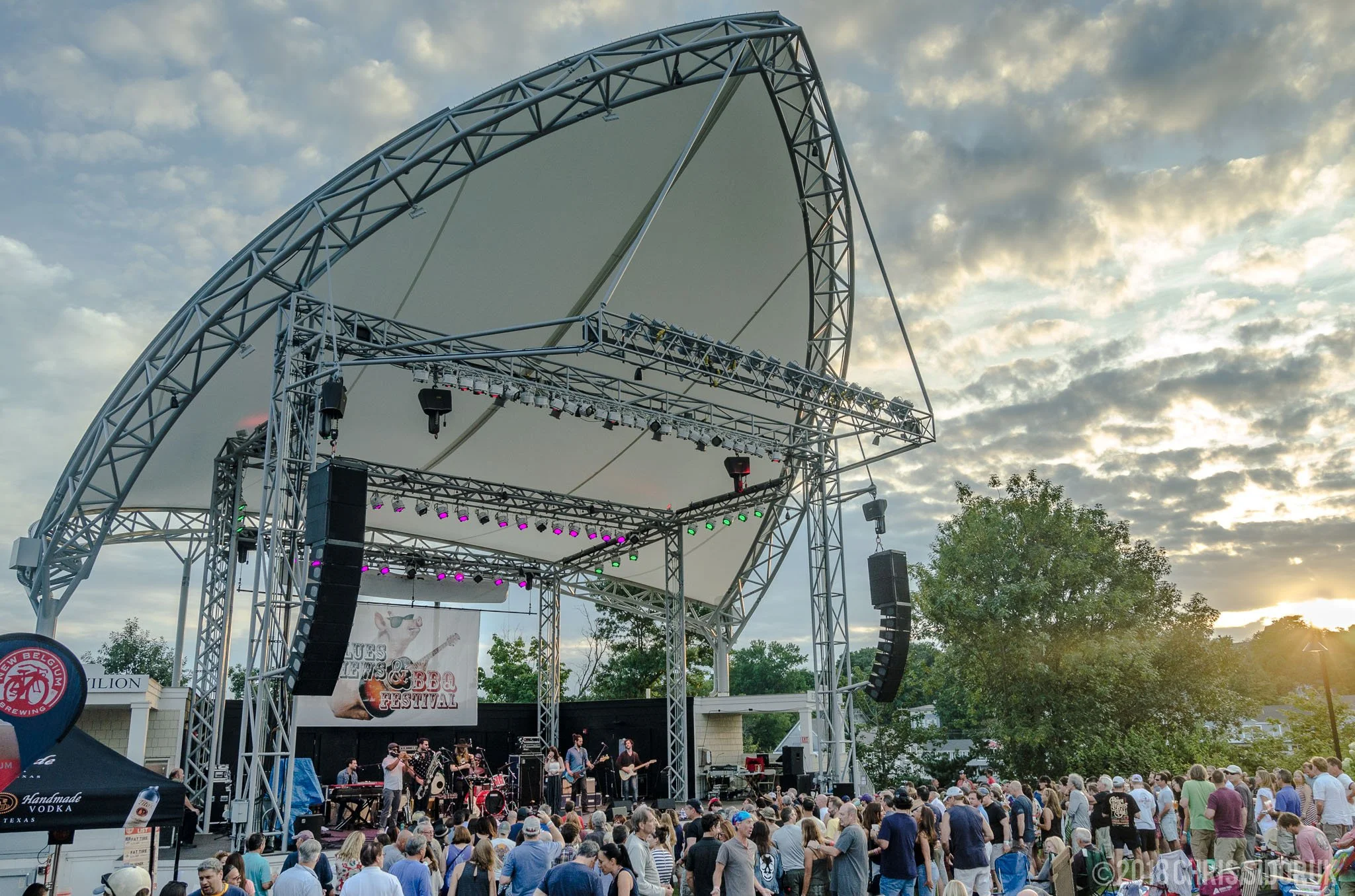 outdoor concert at golden hour in Westport Connecticut with audience on the lawn at Levitt Pavilion