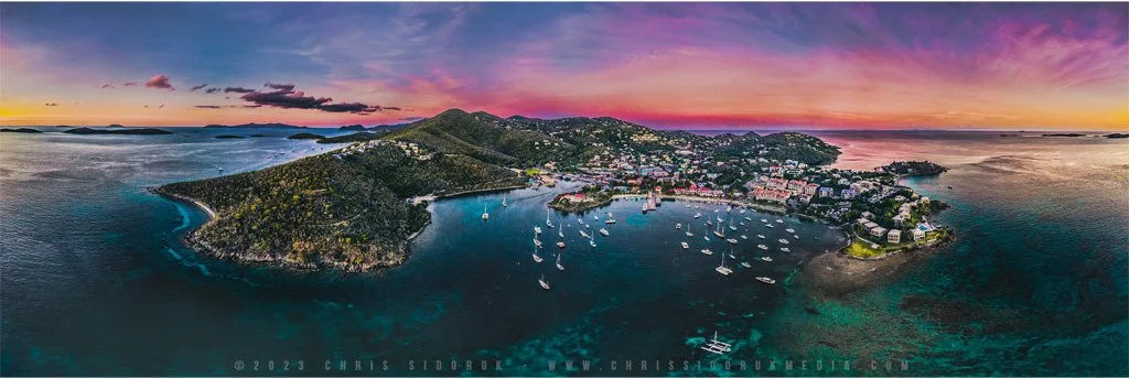 Aerial panorama of Cruz Bay St John USVI at sunset with boats in the harbor and colorful sky