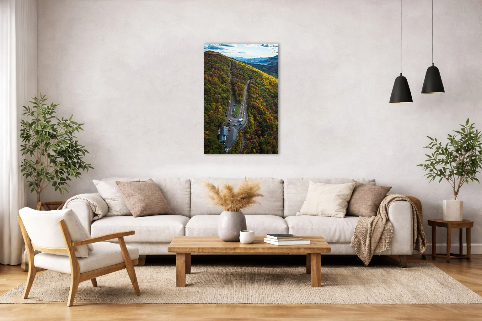 Aerial mountain road photograph with fall foliage displayed in a modern interior space