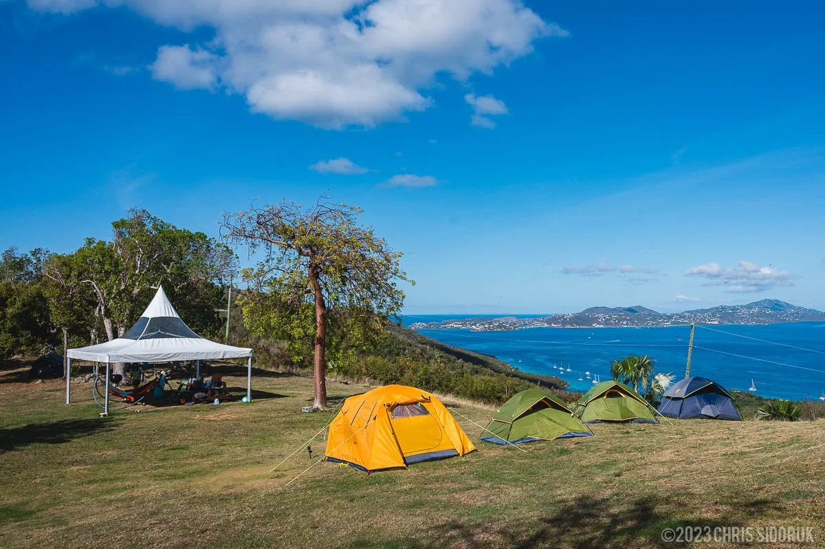 Campground in St John USVI with tents on a hill overlooking the ocean and nearby islands