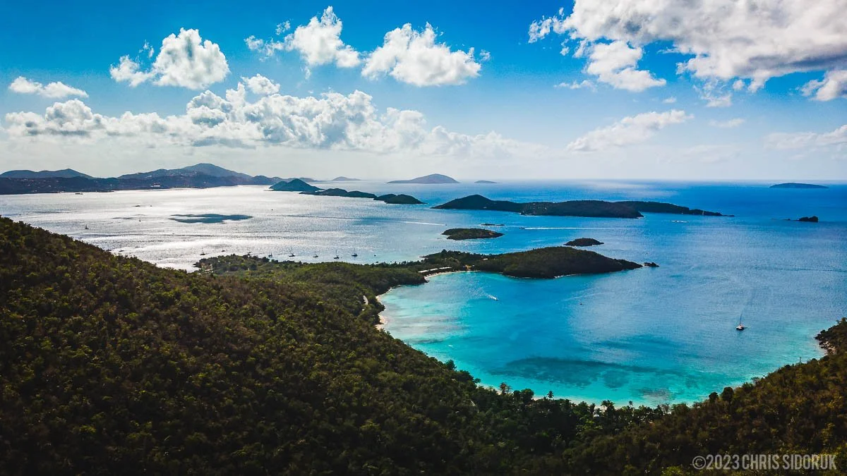 St John USVI north shore overlook with layered islands and bright blue Caribbean water under scattered clouds