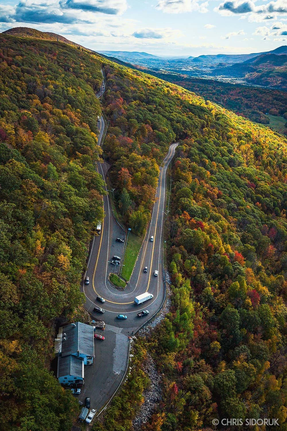The Hairpin Turn in North Adams, Massachusetts winds through the Berkshires during peak fall foliage.