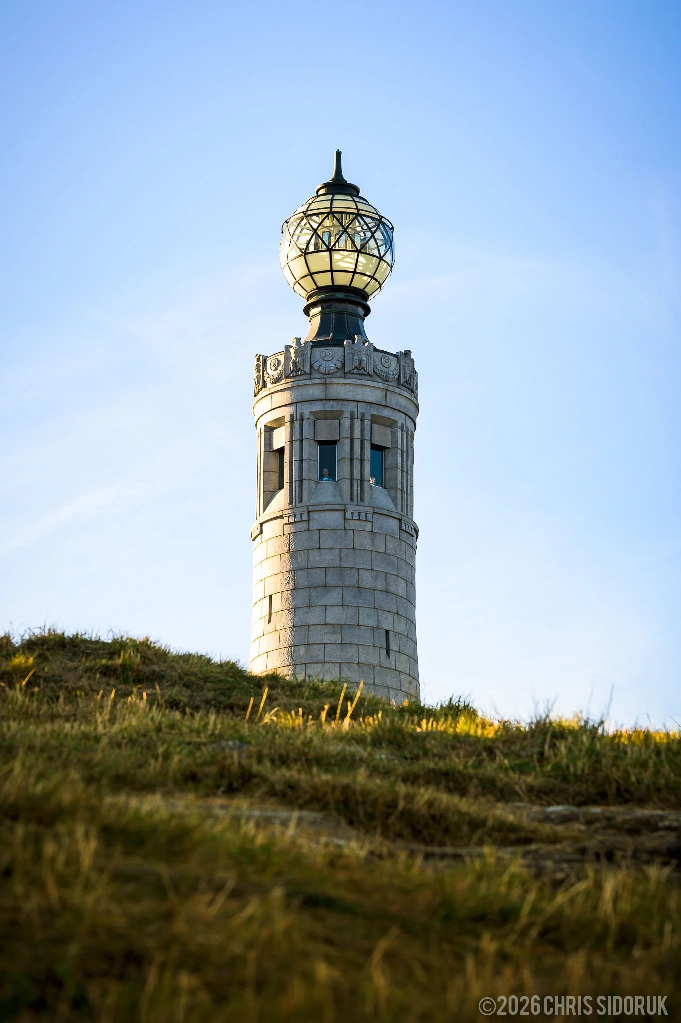 Close-up of the Mount Greylock War Memorial Tower against a clear sky in Massachusetts.