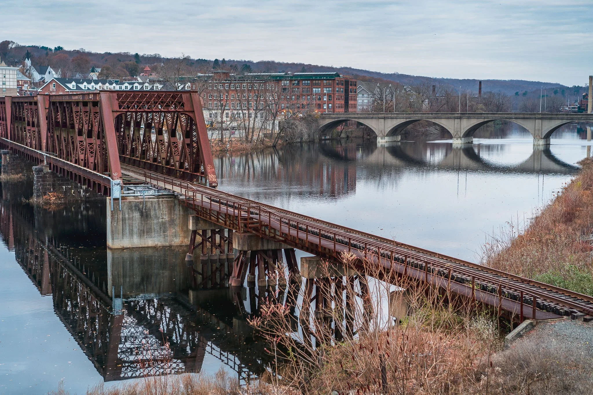 A train trestle bridge and Shelton-Derby Bridge spanning the Housatonic River.