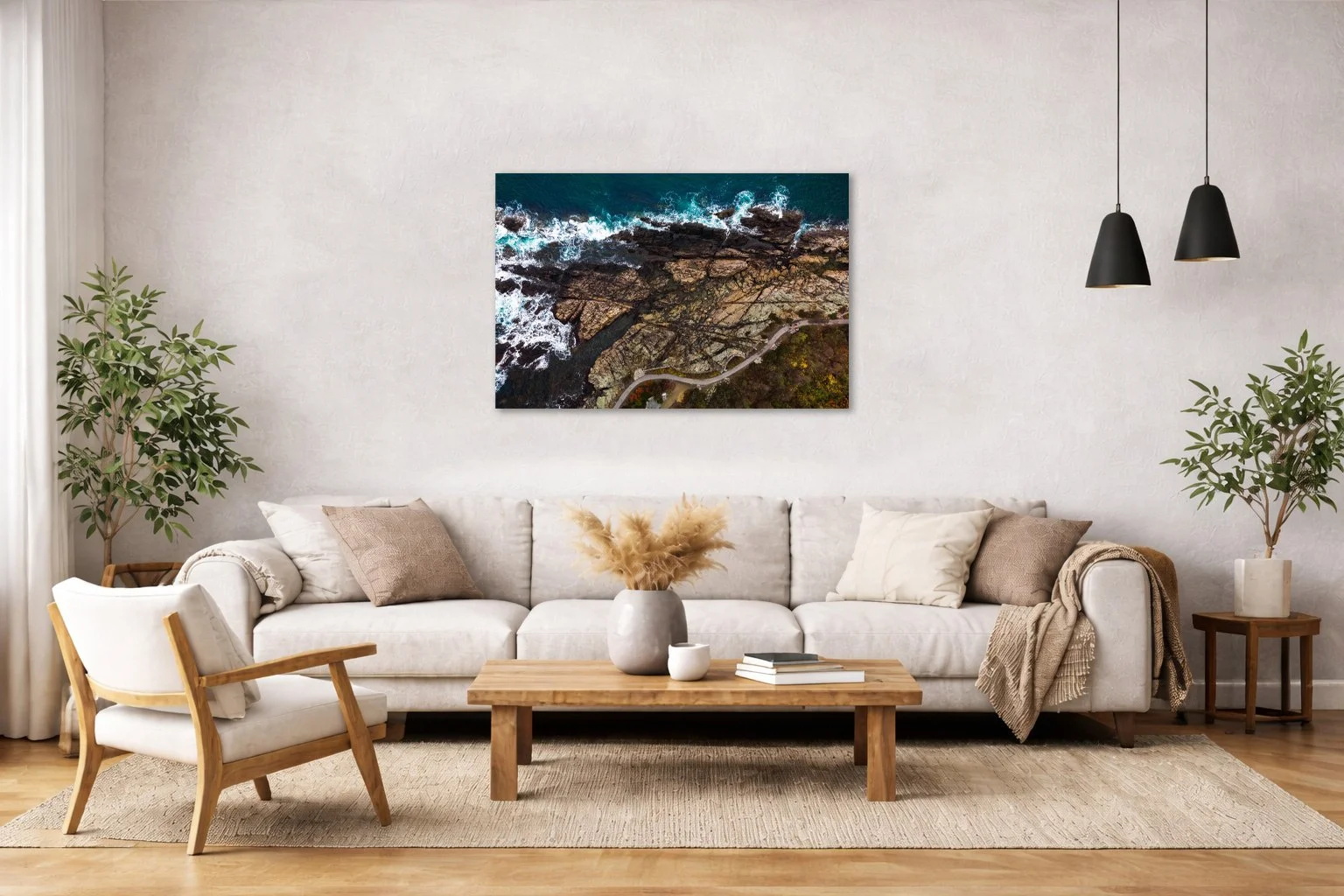 Aerial coastal photograph of waves and rocky shoreline displayed in a modern interior space