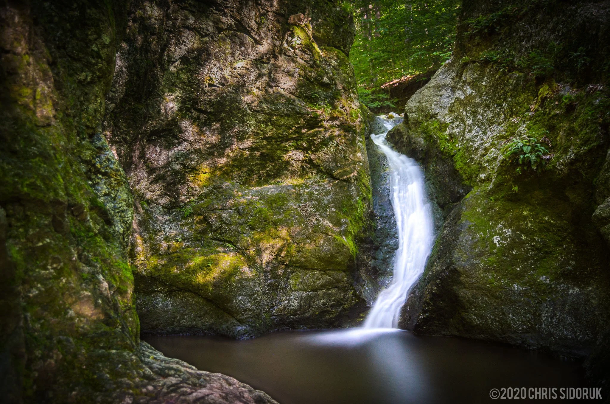 Scenic view of the waterfall and well at Indian Well State Park in Shelton, Connecticut.