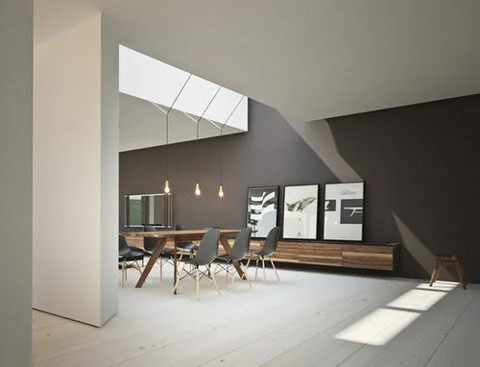 Modern dining room interior with minimalist design, featuring a wooden table, gray chairs, pendant lighting, and framed artwork on dark walls. Large windows provide natural light on light wood flooring.