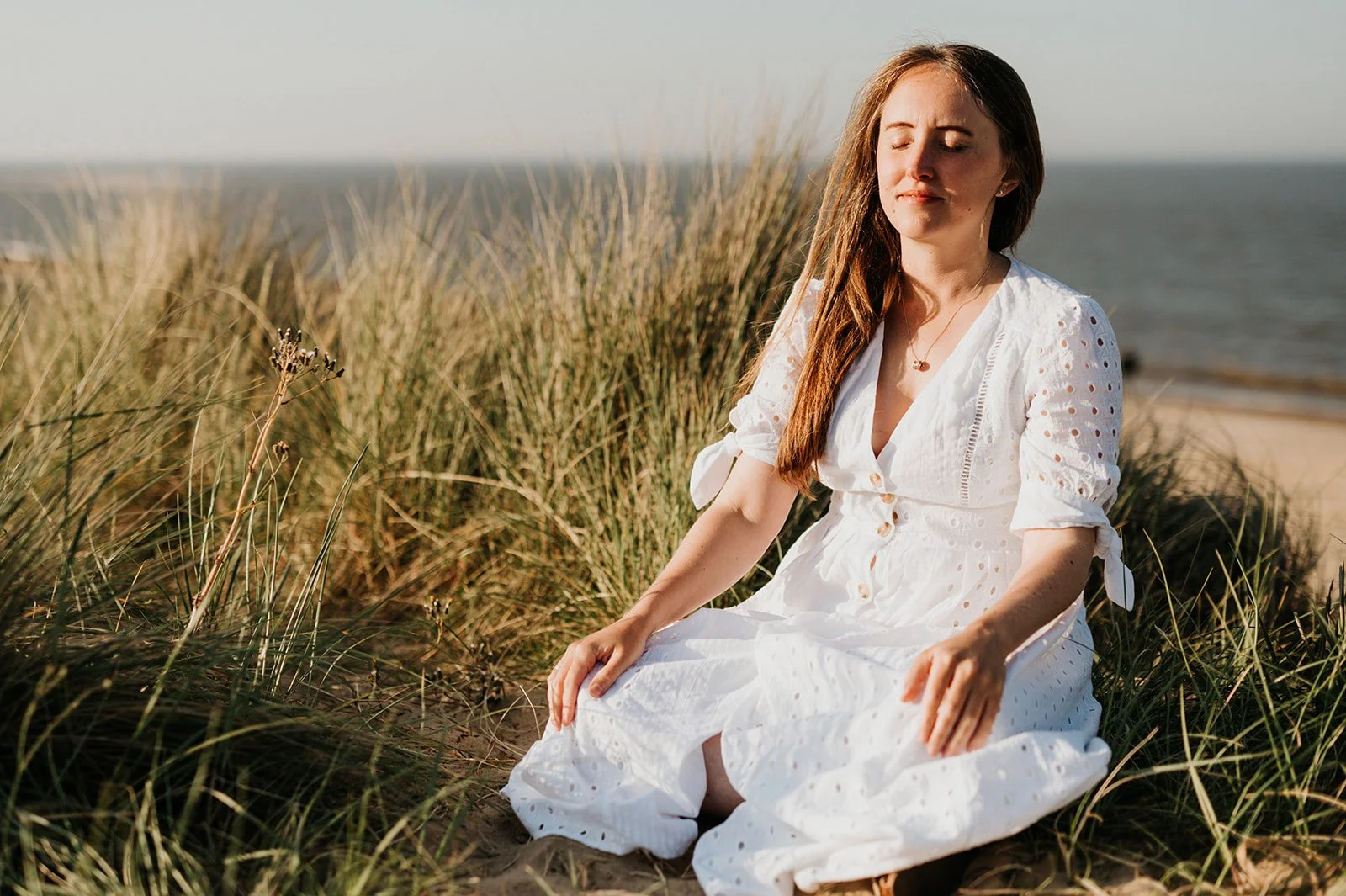 woman on the beach meditating