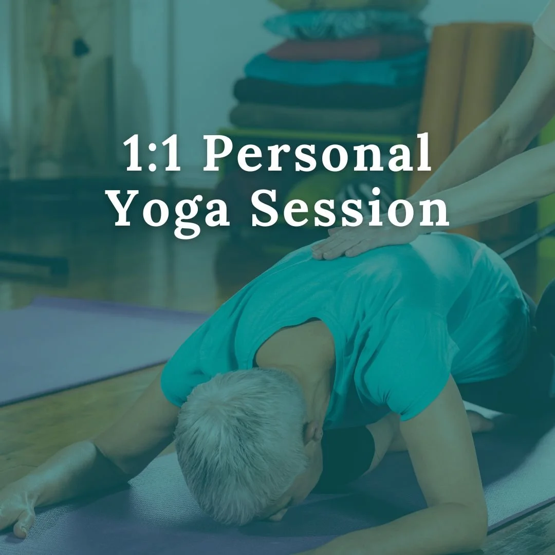 A person with short, gray hair doing a yoga pose on a purple mat in a room with a stack of folded towels or clothes in the background, with text overlay reading '1:1 Personal Yoga Session'.