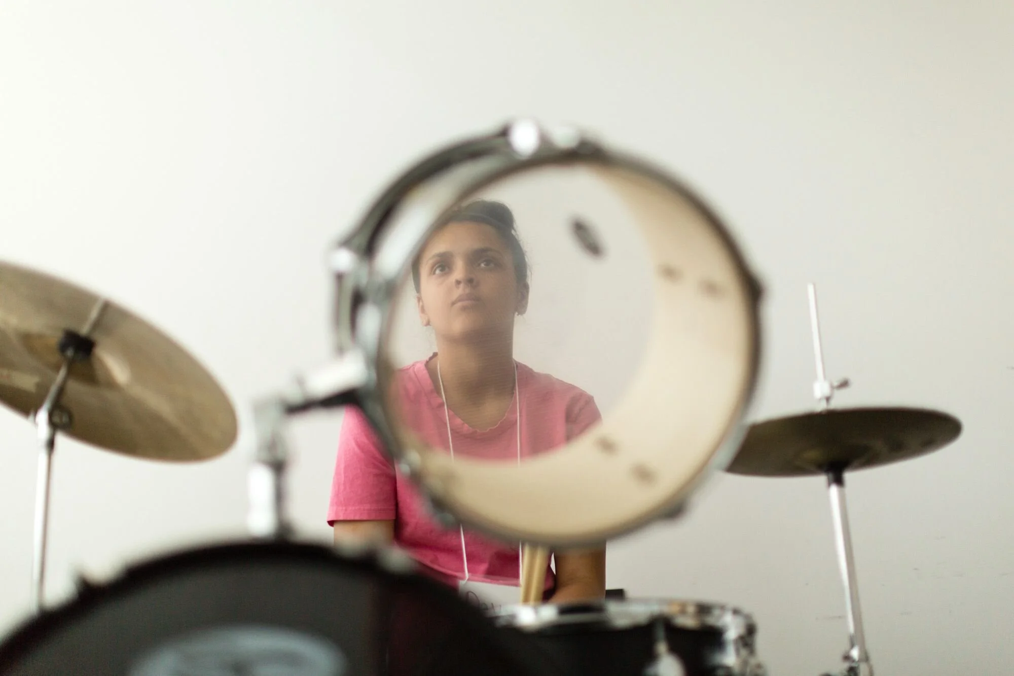 Shot of youth through a rack tom of a drum kit
