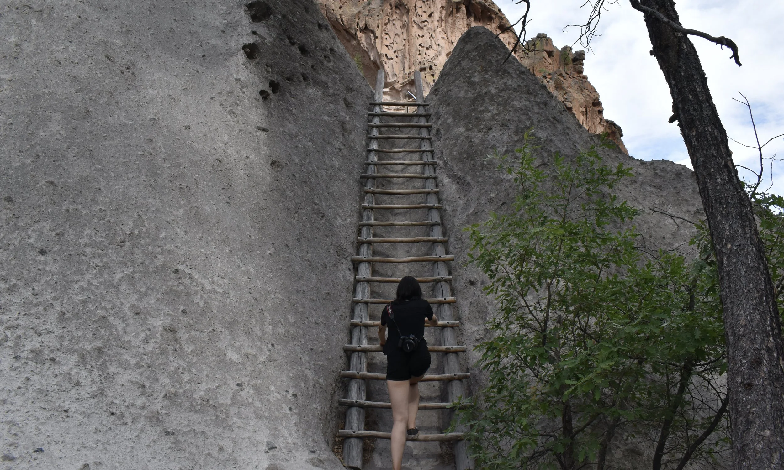Wife on a Ladder at Alcove House at Bandelier National Monument