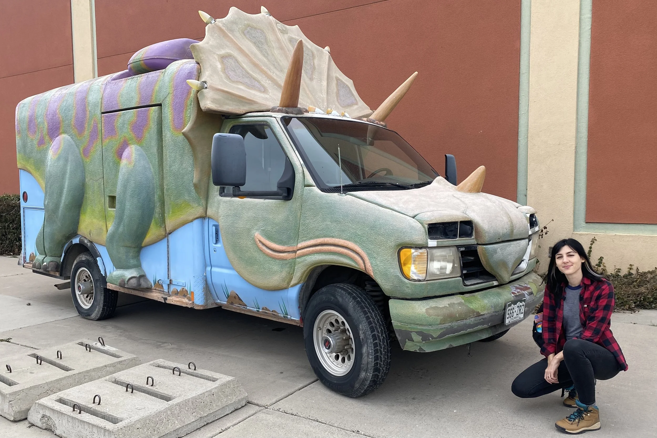 My wife next to a Triceratops car at the Dinosaur Journey Museum in Fruita, Colorado.