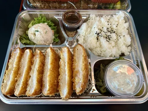 A bento box containing shrimp katsu patties served with Koshihikari rice.