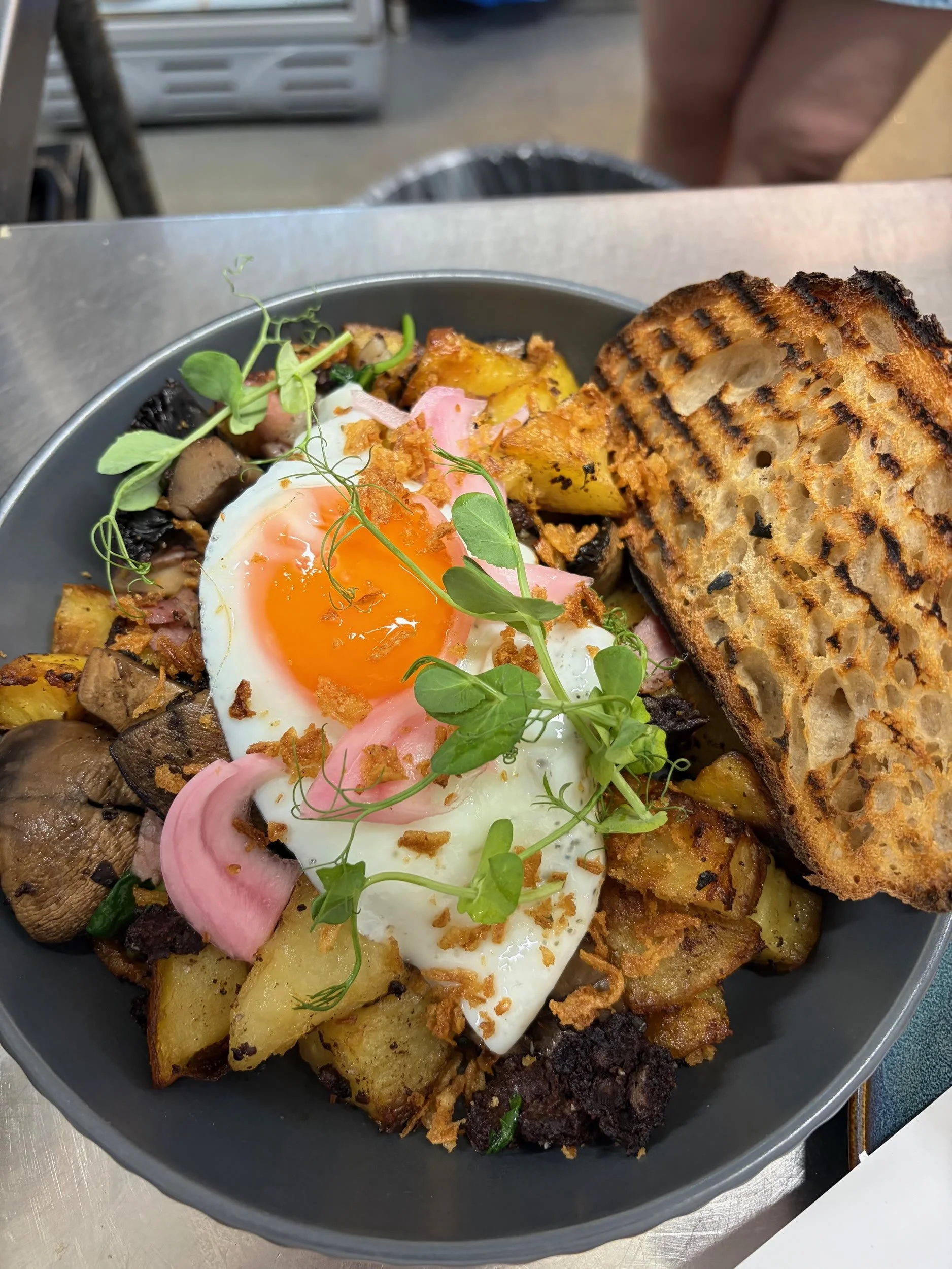 Fried egg on a potato hash with toasted sourdough