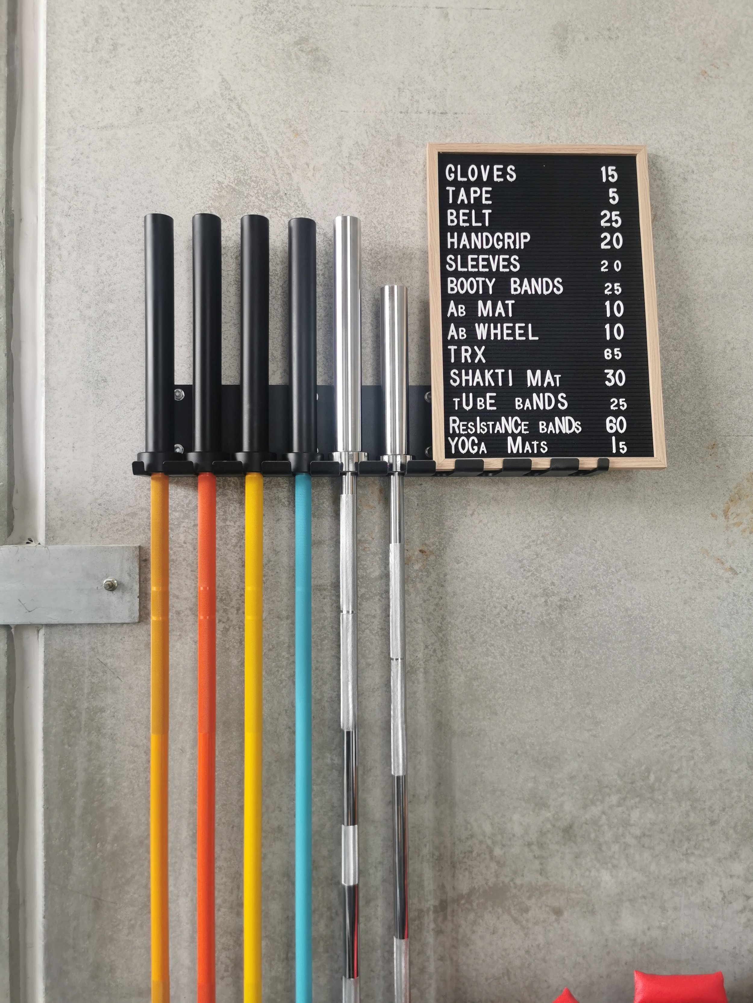 wall mounted barbell rack holding barbells
