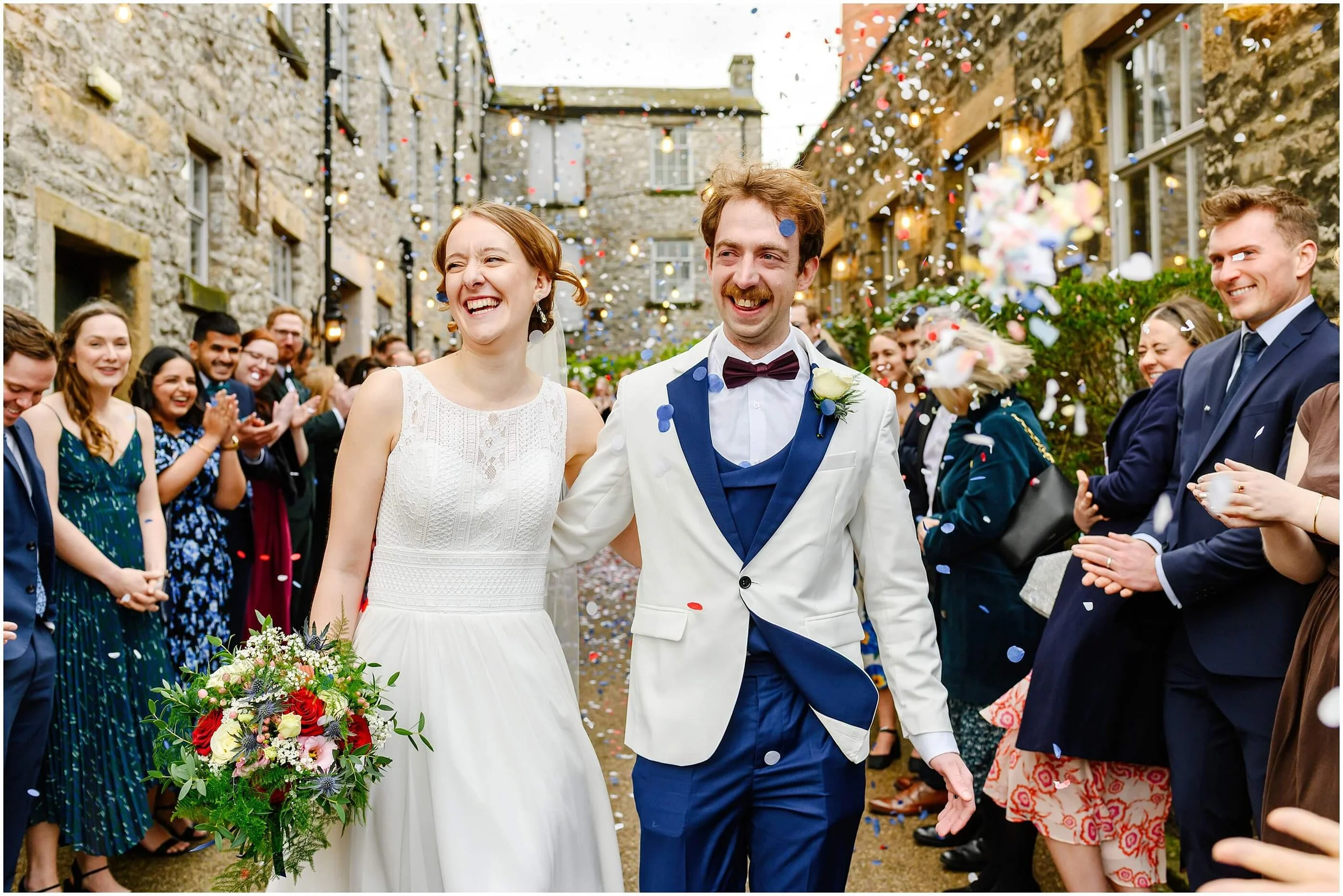 wedding photograph taken outside Holmes Mill in Clitheroe as confetti is thrown