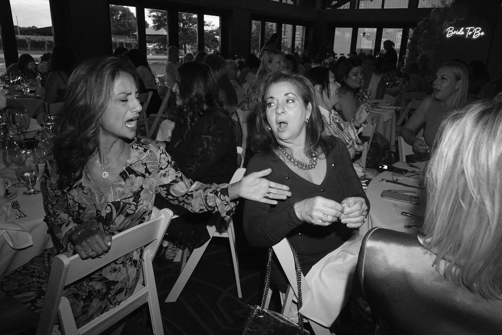 Two Italian women in a heated debate at a wedding reception in Niagara on the Lake at Trius Winery by Andreas Avdoulos Photographer