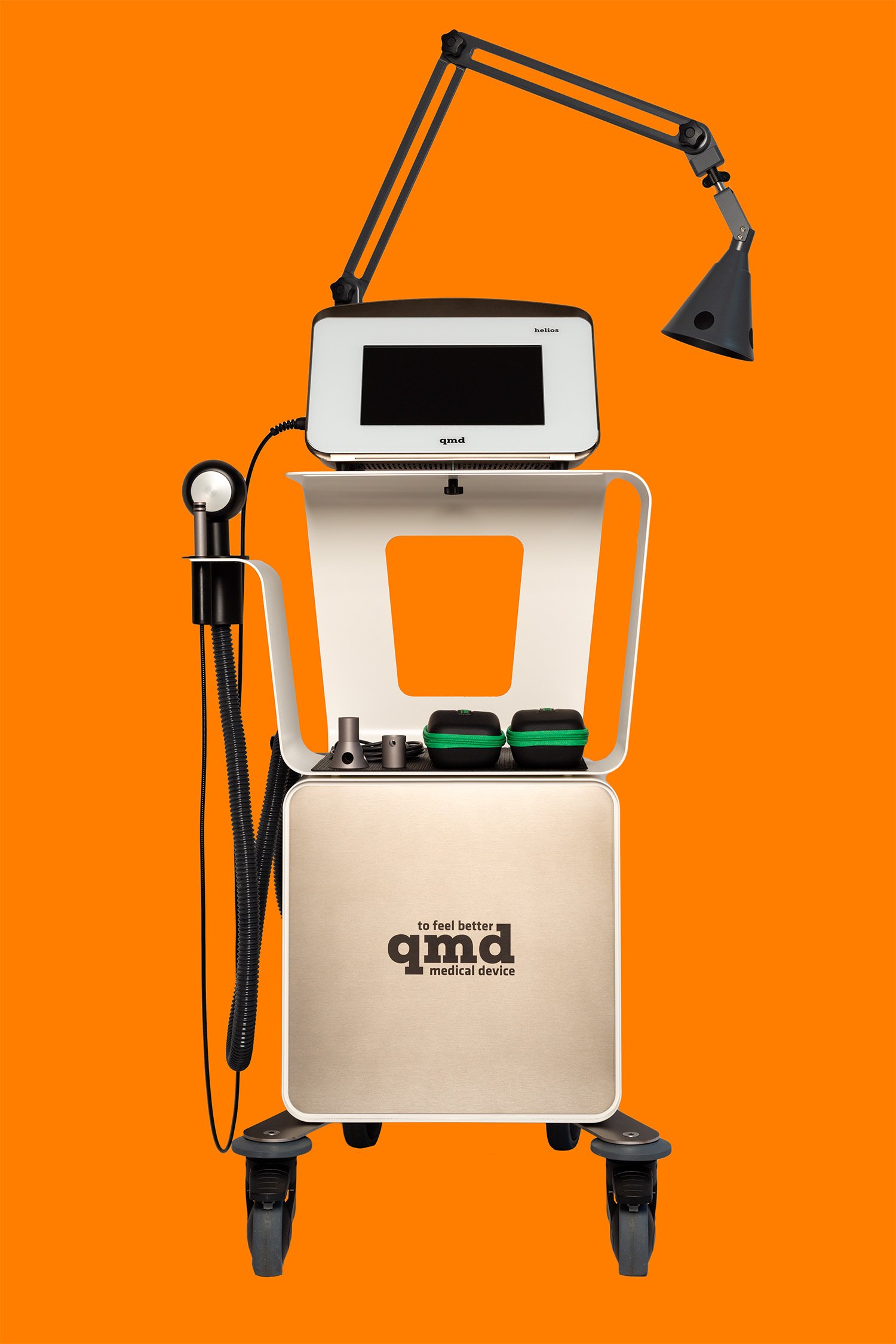 Dispositivo medico con schermo, luci e attrezzi, su carrello su sfondo arancione.