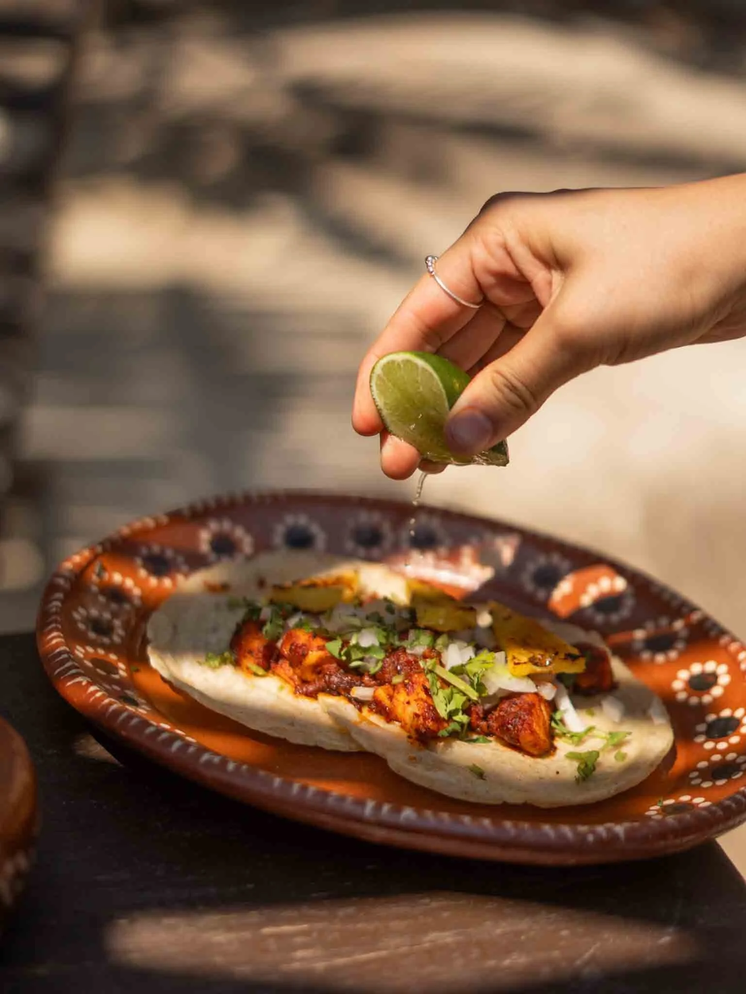 Limón exprimiéndose sobre Tacos de pescado al pastor  hotel baxar acapulco pie de la cuesta