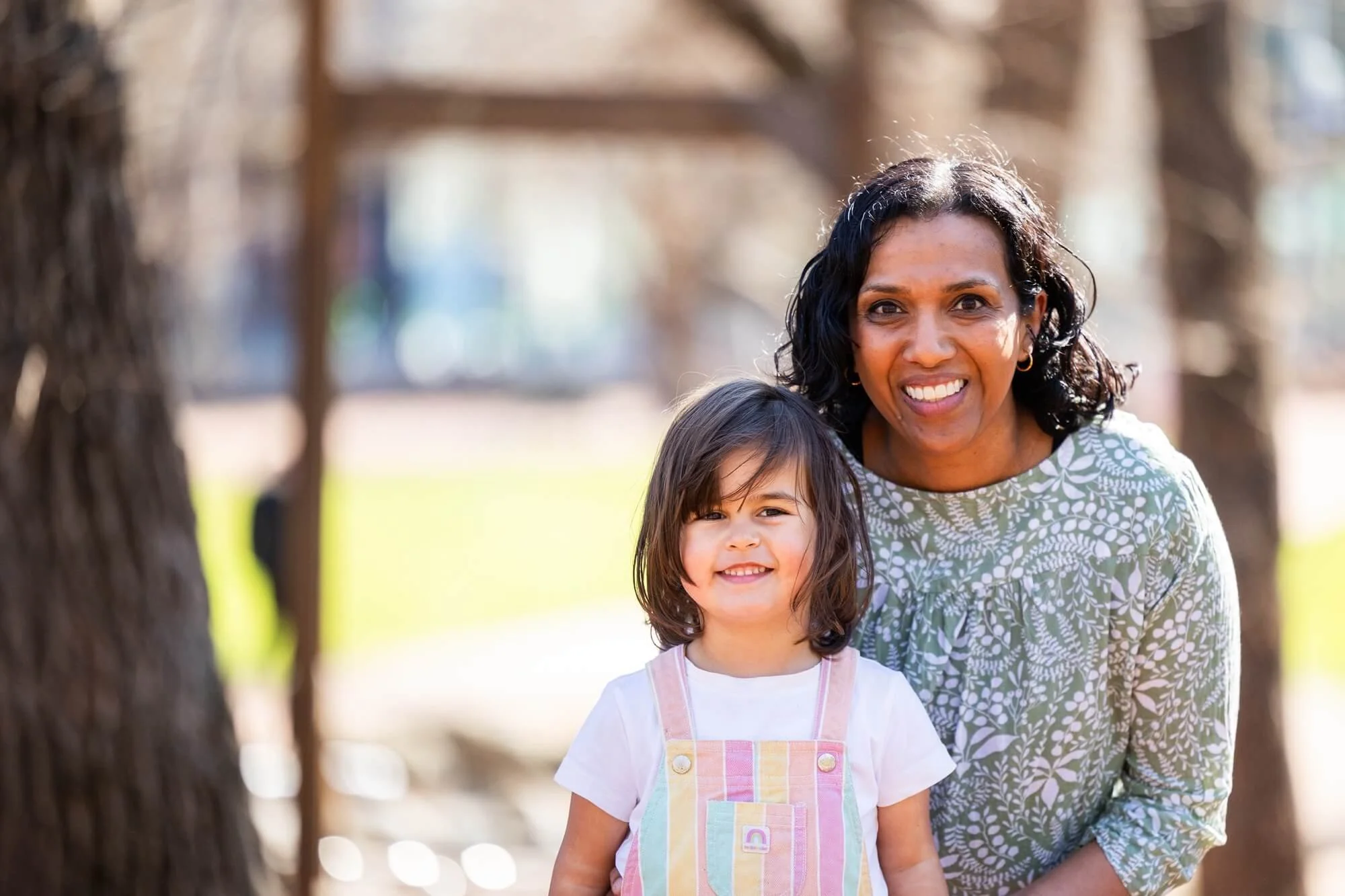 Annette Carroll, winner of the 2026 Research Impact Grant, sitting with a young child at an outdoor play area.