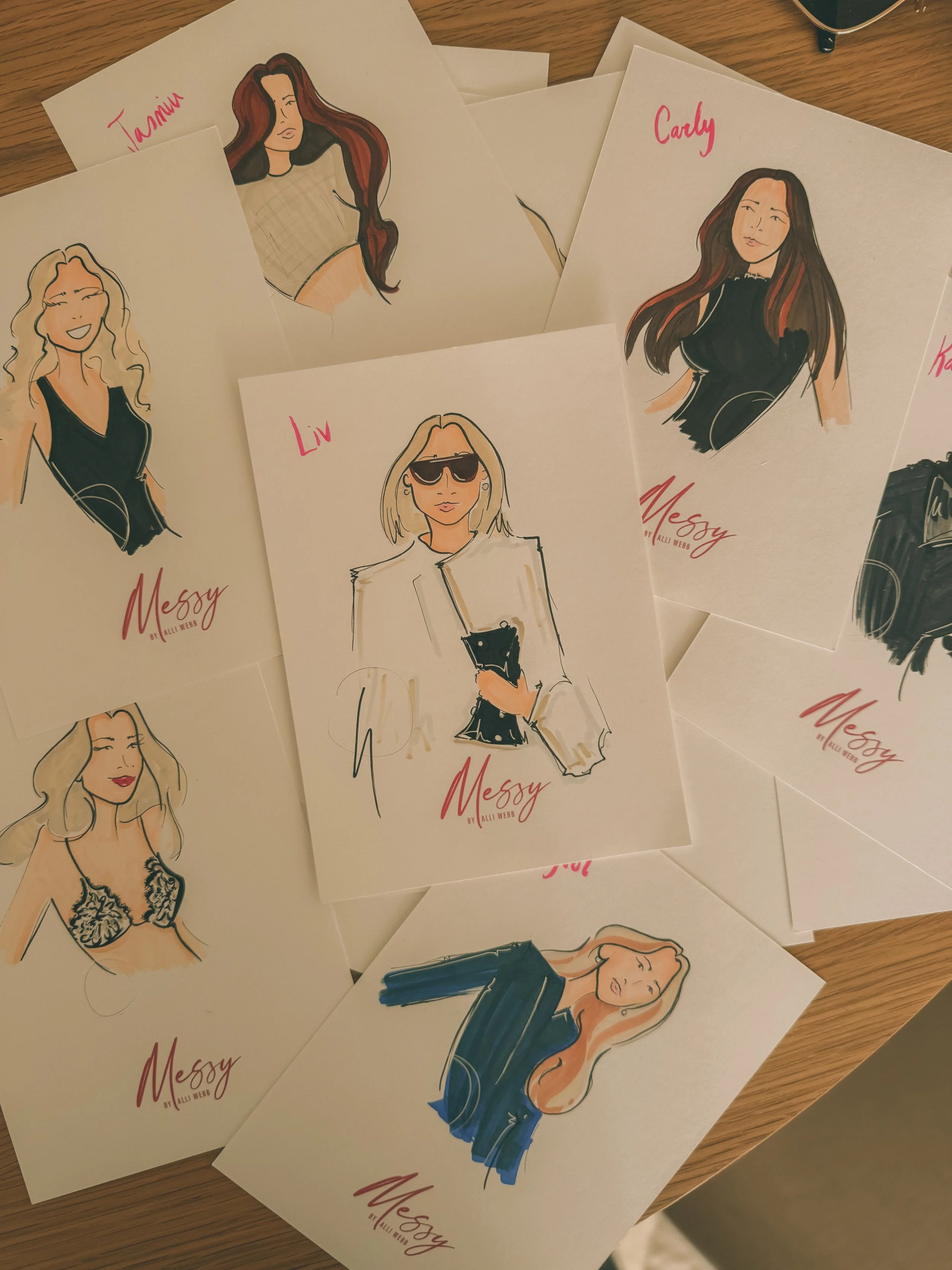 Assorted fashion illustration sketches of women, some with handwritten names like 'Tasia,' 'Carly,' 'Liv,' and 'Kait,' featuring various hairstyles and outfits, with the word 'Messy' and the signature 'Alli Webb' on each.