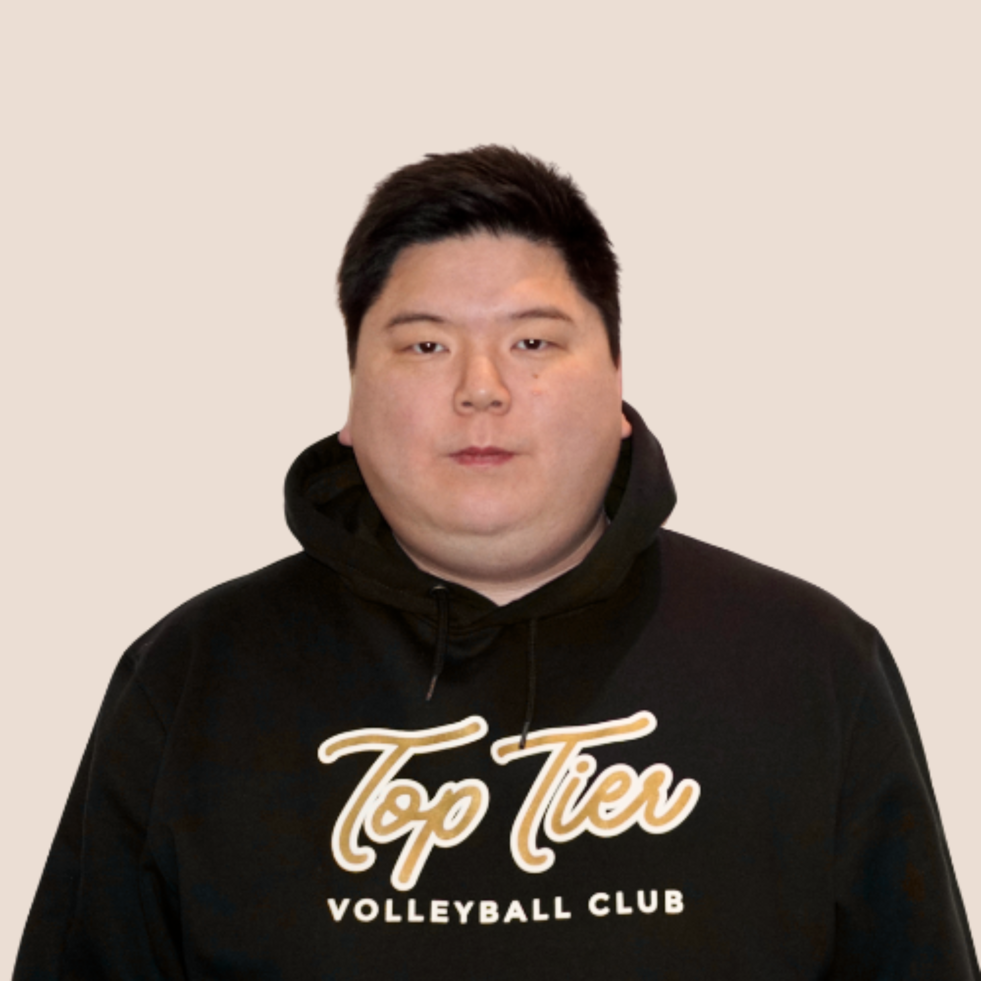 A young man with short dark hair wearing a black hoodie with 'Top Tier Volleyball Club' written on it, standing against a white background.