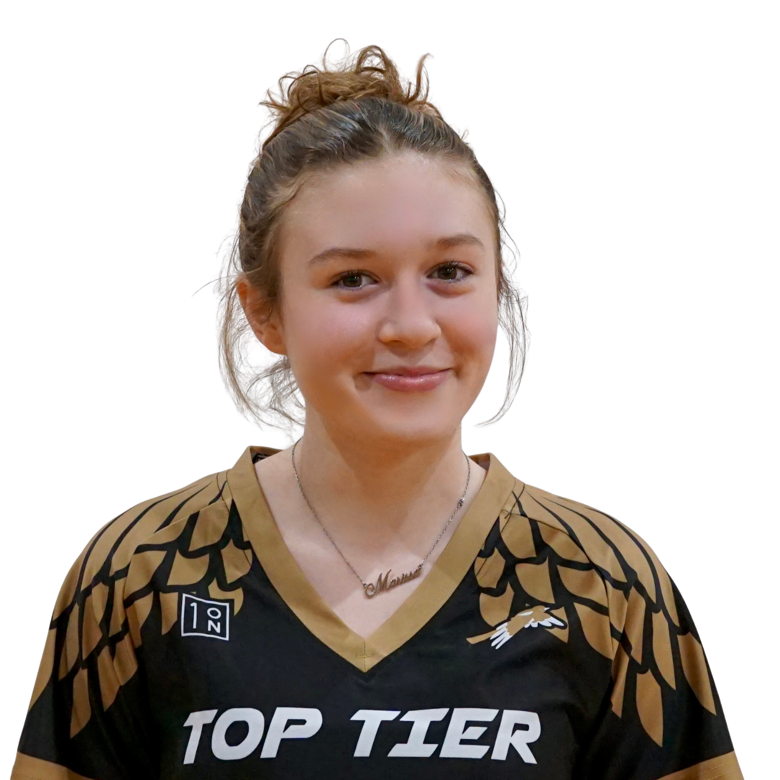 A young woman with light skin and brown hair tied back in a messy bun, wearing a black and gold sports jersey with 'TOP TIER' written on it, and a necklace with a name plate that says 'Momma'.
