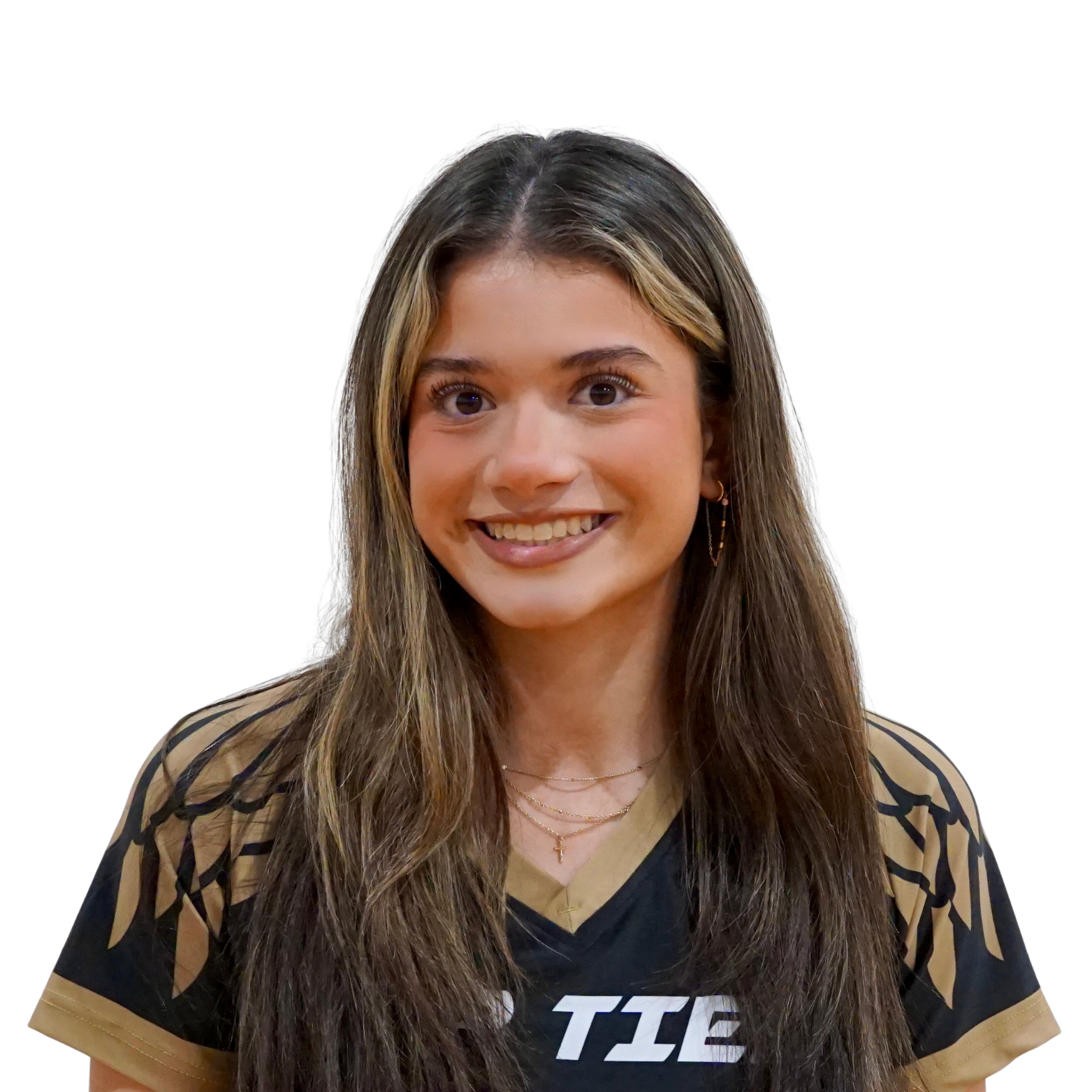 A young woman with long brown hair and light skin, smiling, wearing a black and gold sports jersey and layered necklaces.