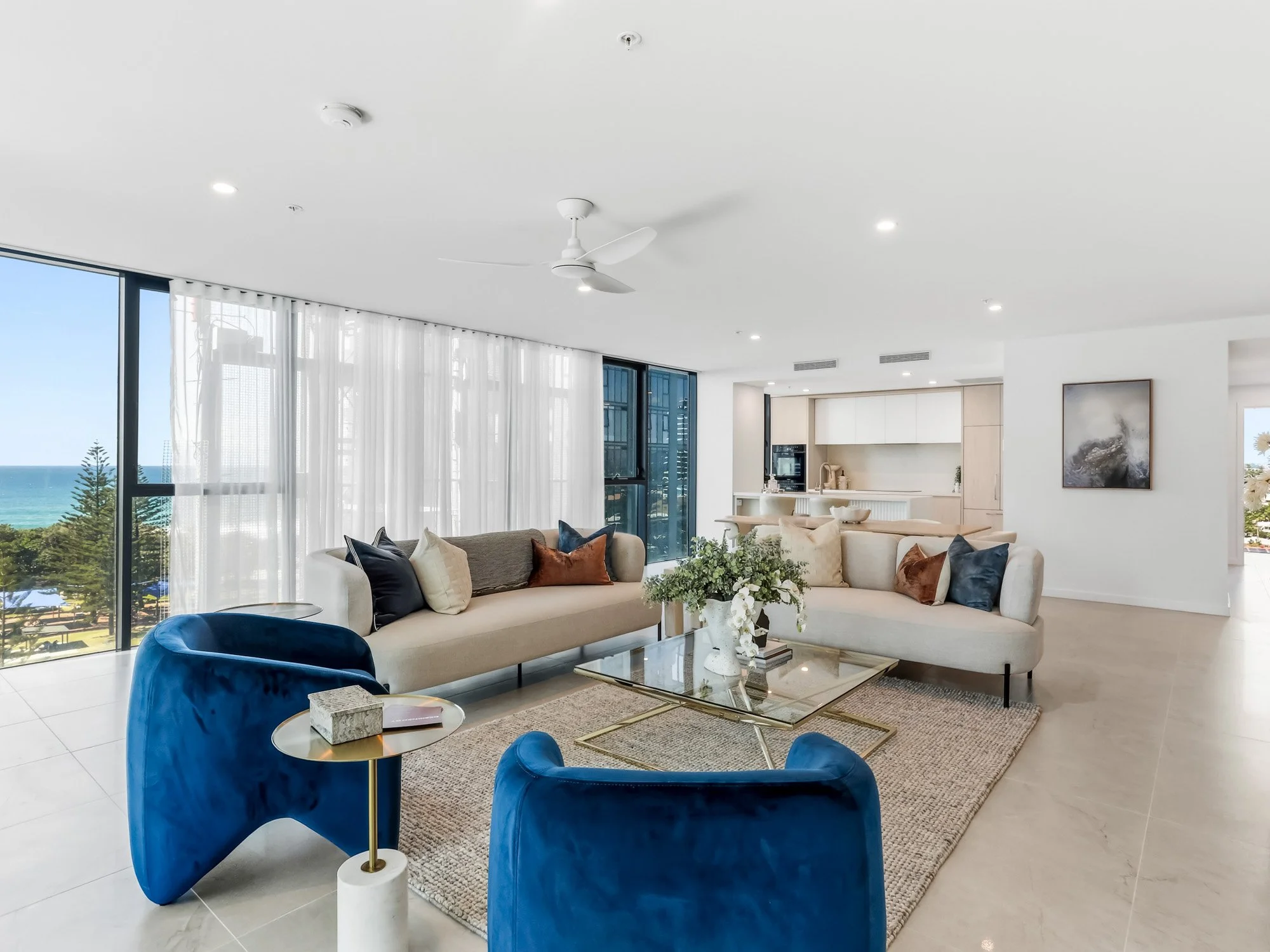 Large modern living room with blue chairs