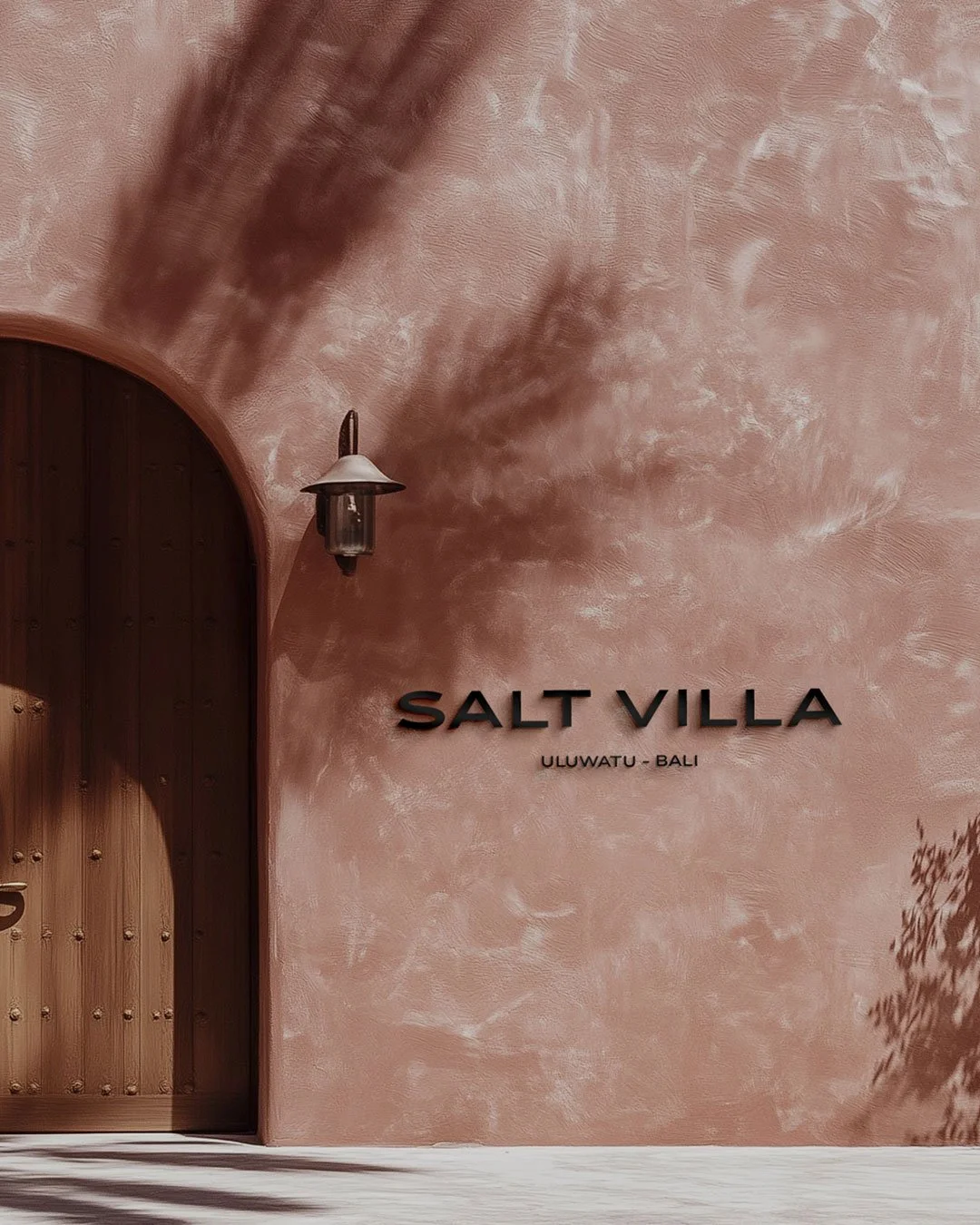 Boutique hotel exterior design showcasing branding and signage beside the door