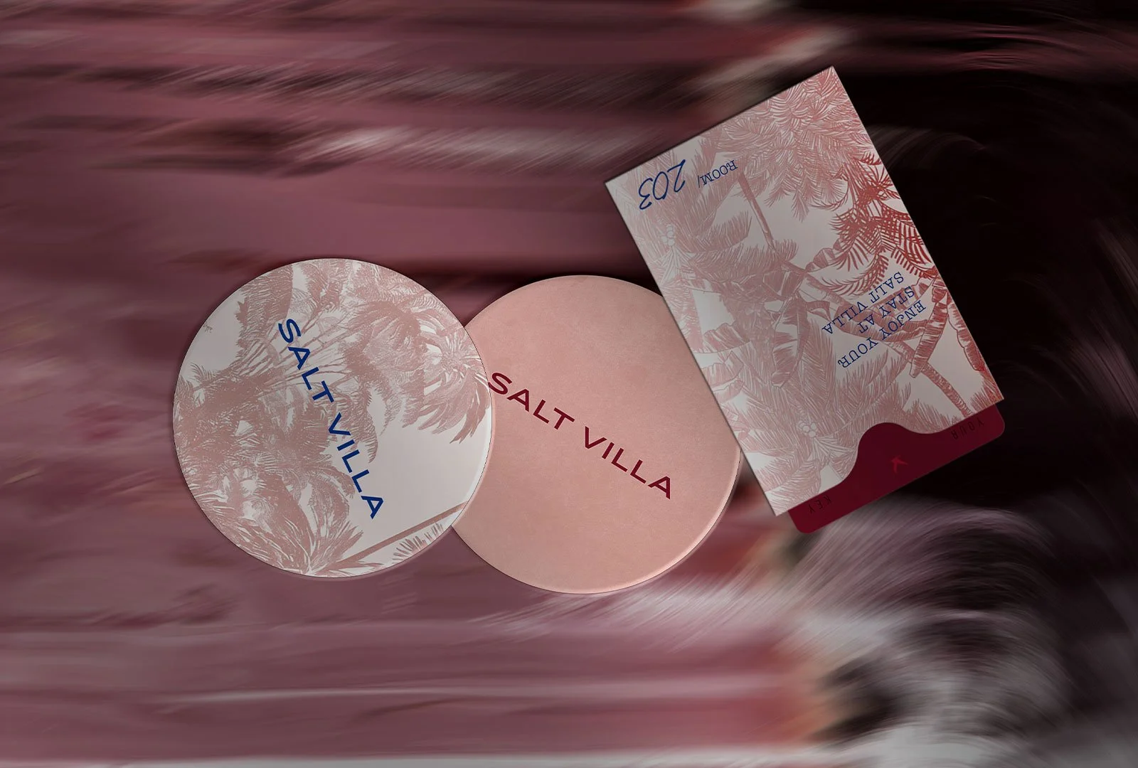 Coaster and room key with pink brand pattern of a boutique hotel brand in Bali.