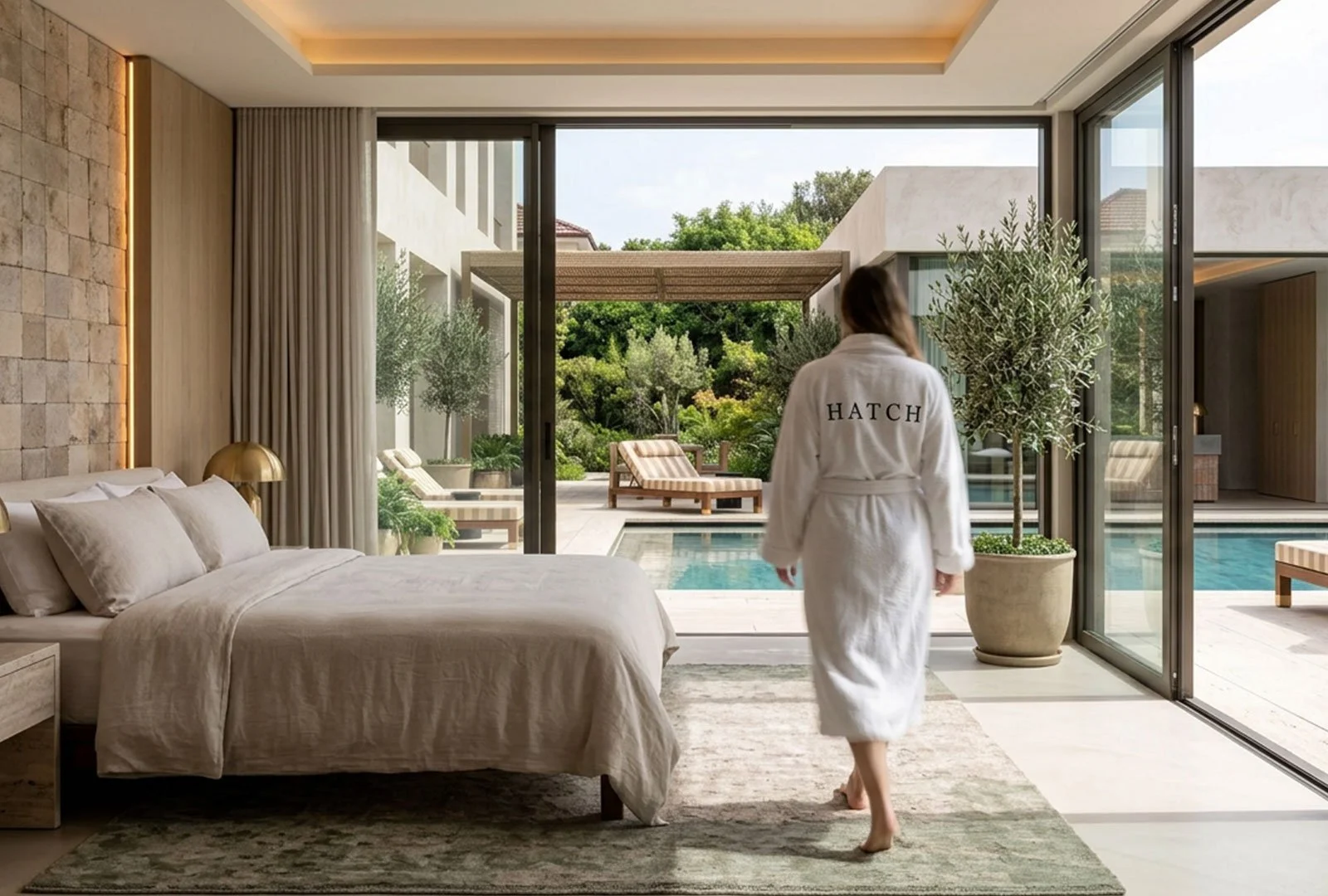 Woman walking in the room showcasing embroidery hatch robe that's one of the applications of visual identity
