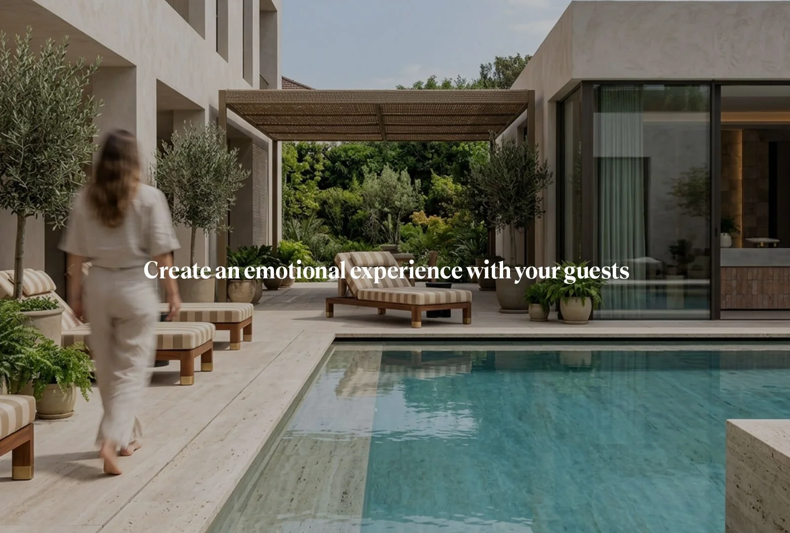 Woman walking by the pool of a hotel that has a minimal visual identity and beige color tones
