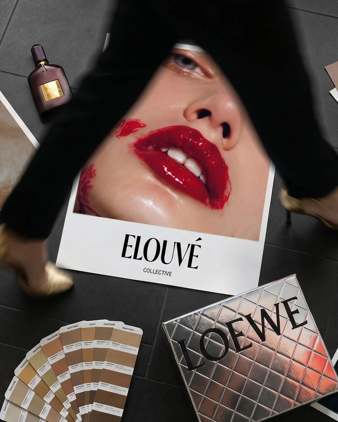 Poster of boutique creative agency in London, Elouvé Collective with model walking in the scene above the poster, wearing golden heels. Other props from luxury brands like Loewe can be seen in the scene