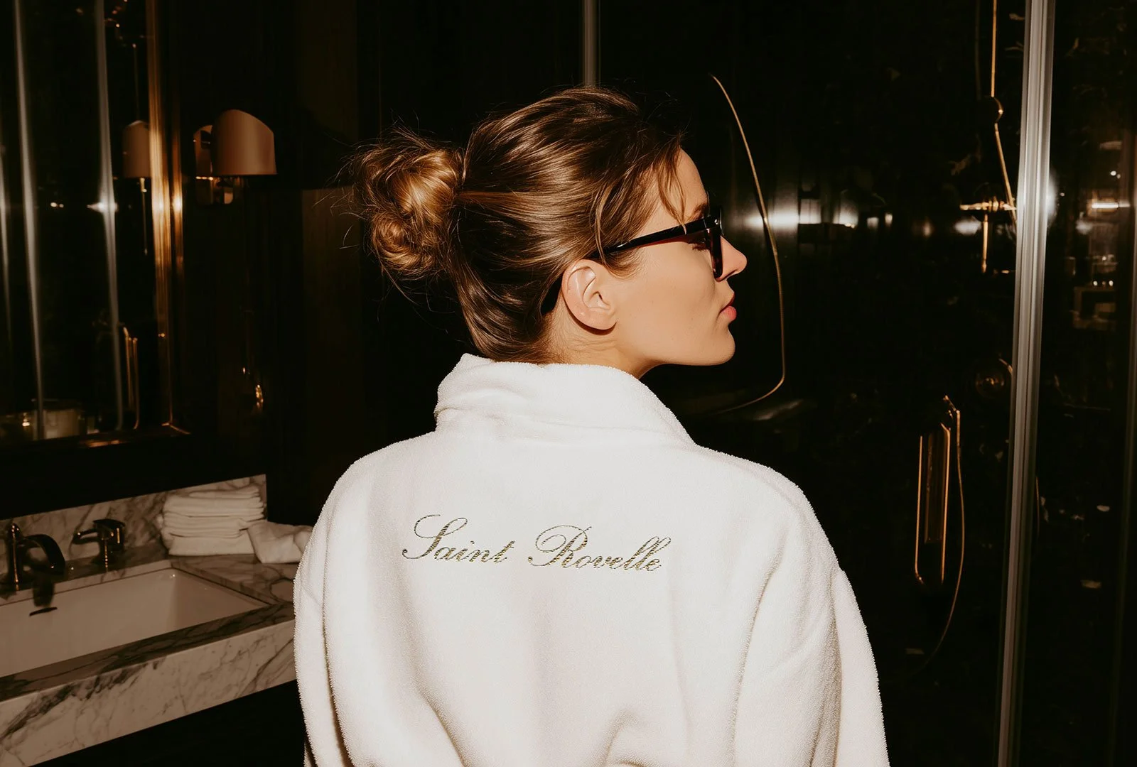 guest enjoying the hotel experience in Sant Rovelle wearing branded robe with logo
