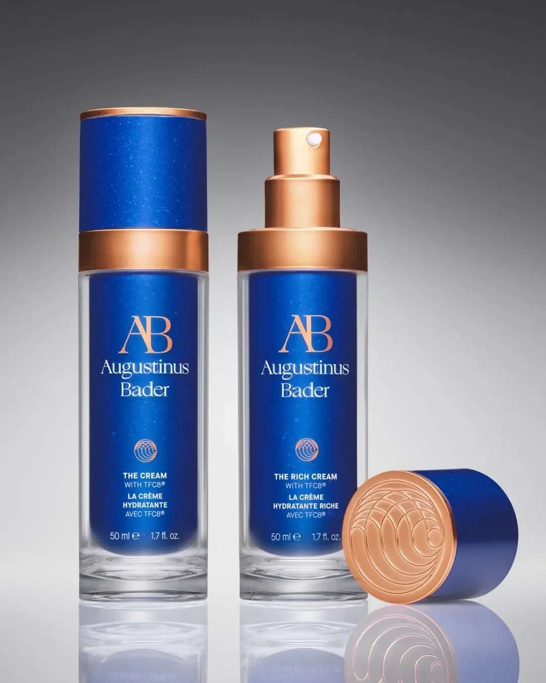 Two vibrant cobalt blue and copper metallic cosmetic pump bottles showing Augustinus barder packaging