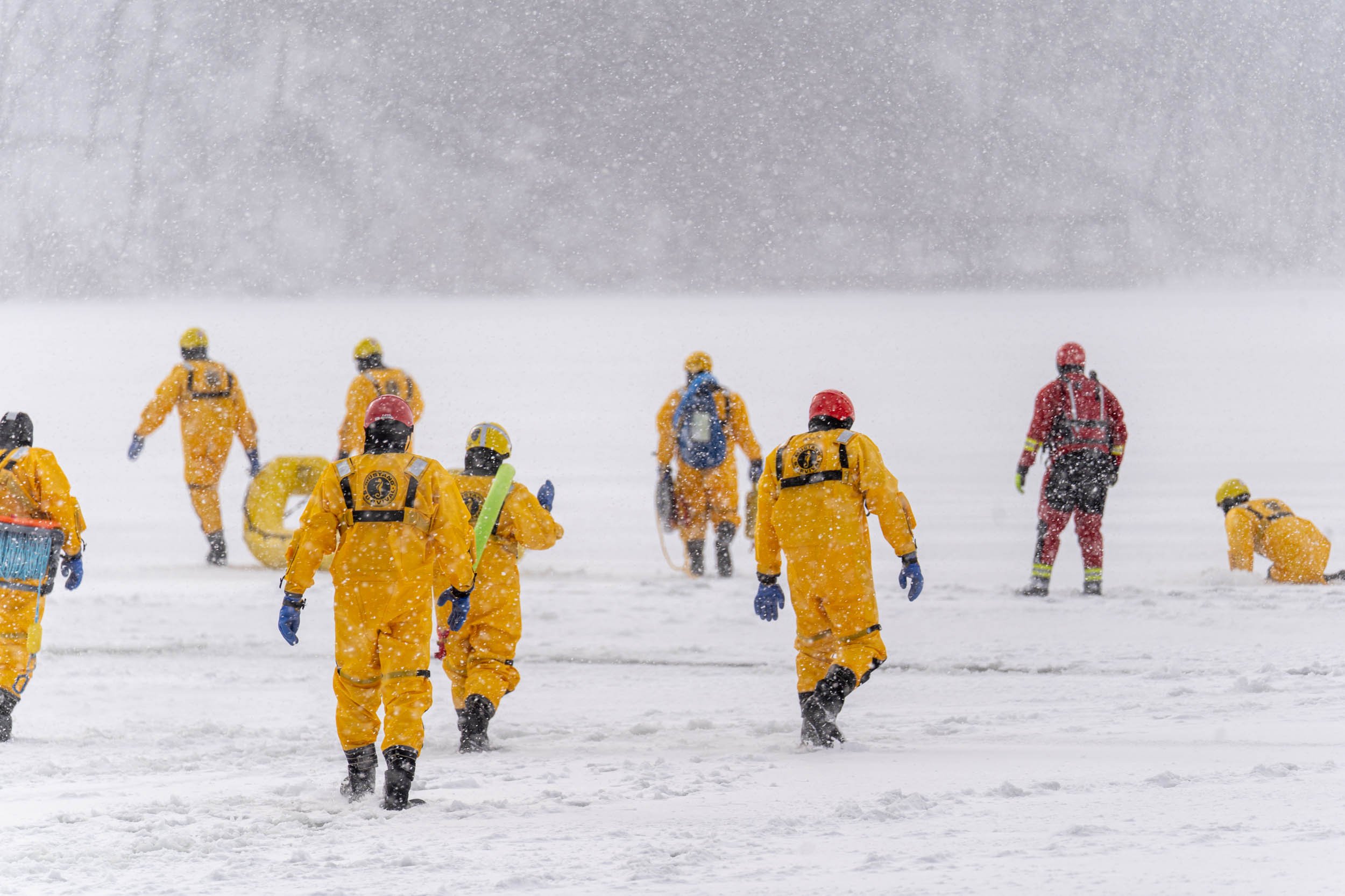 Members of the Irondeqouit Fire Station train for ice rescues in Irondequoit Bay, NY on February 18, 2022. New York firefighters train for ice rescues once a year and spend an hour out in the freezing temperatures.