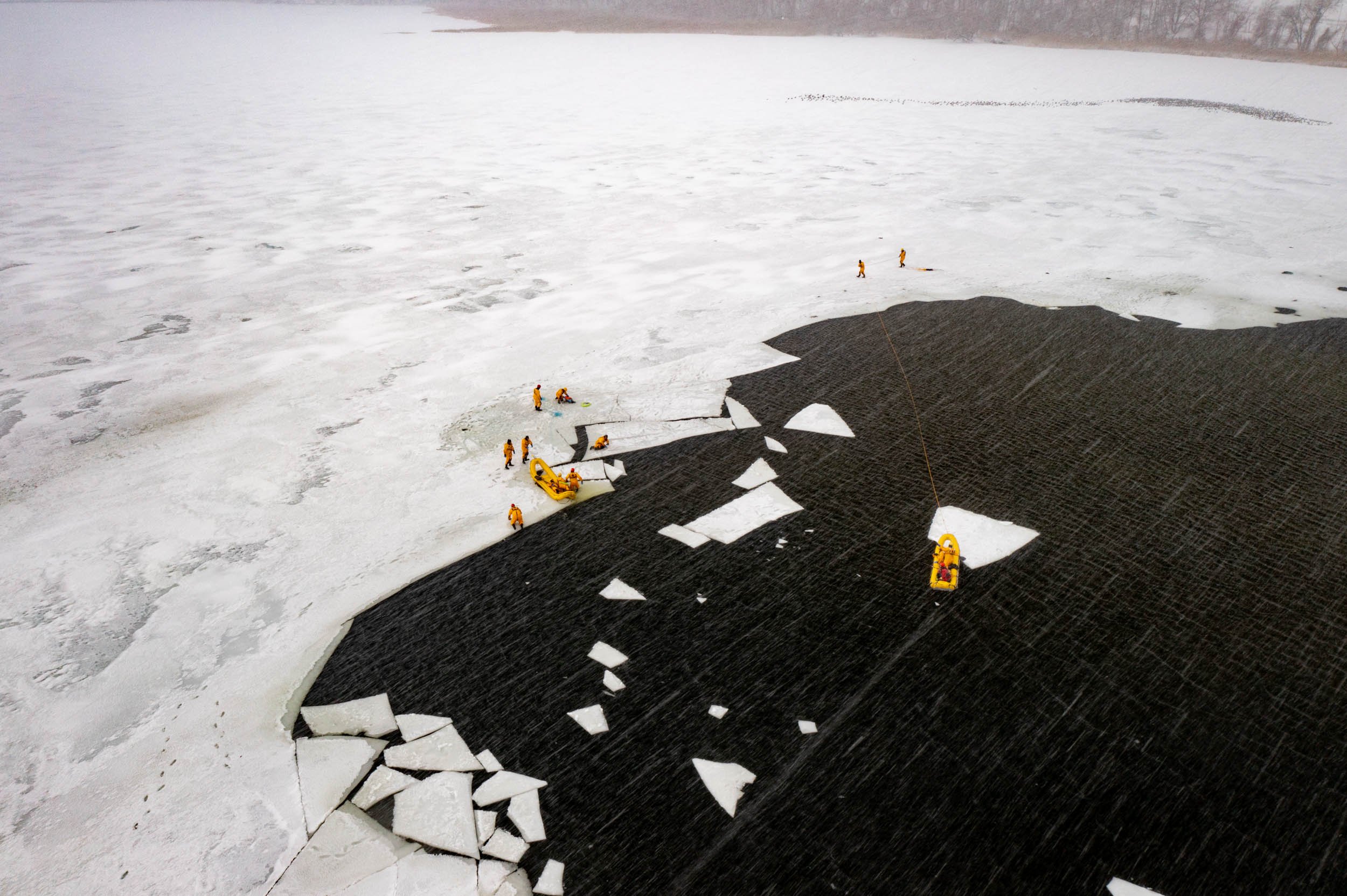 Members of the Irondeqouit Fire Station train for ice rescues in Irondequoit Bay, NY on February 18, 2022. New York firefighters train for ice rescues once a year and spend an hour out in the freezing temperatures.