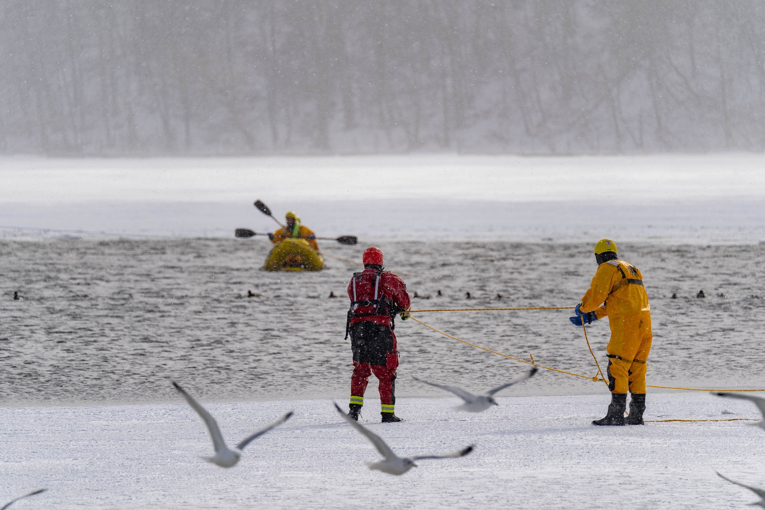 Members of the Irondeqouit Fire Station train for ice rescues in Irondequoit Bay, NY on February 18, 2022. New York firefighters train for ice rescues once a year and spend an hour out in the freezing temperatures.