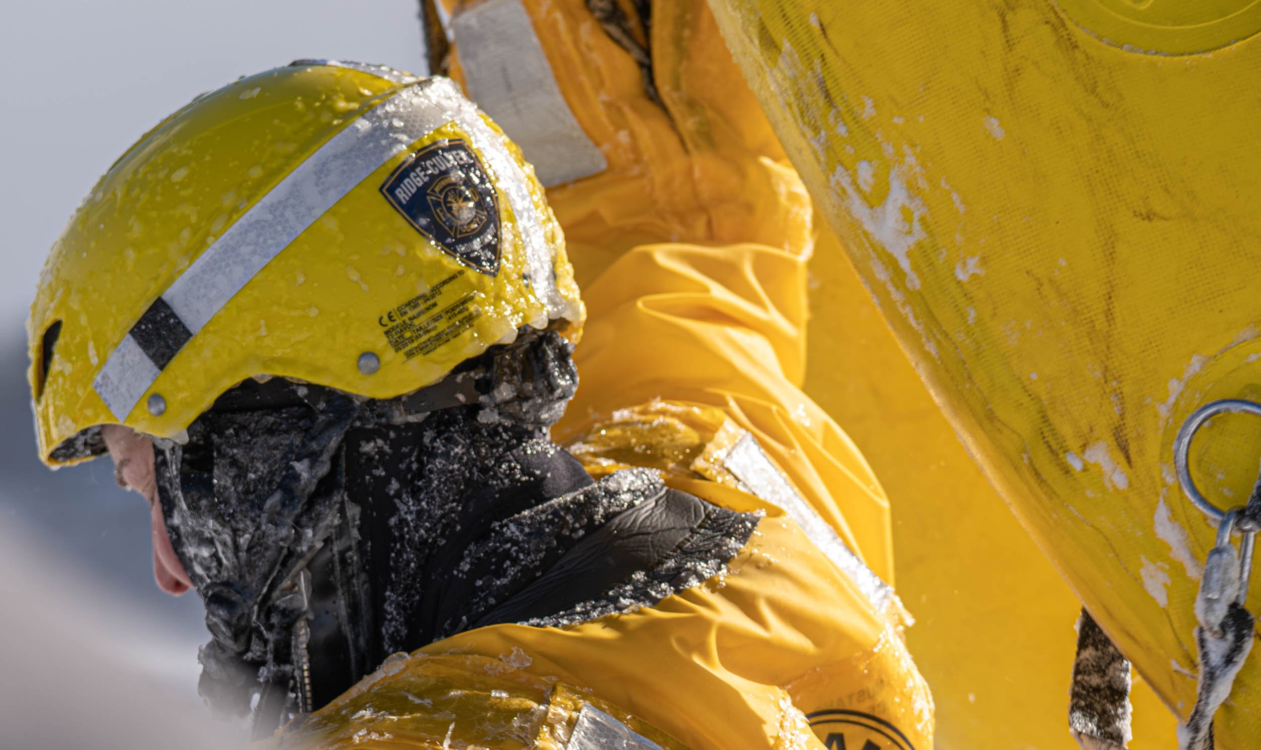 Laura Johnson of the Irondeqouit Fire Station carries raft for ice rescues training in Irondequoit Bay, NY on February 18, 2022. New York firefighters train for ice rescues once a year and spend an hour out in the freezing temperatures.
