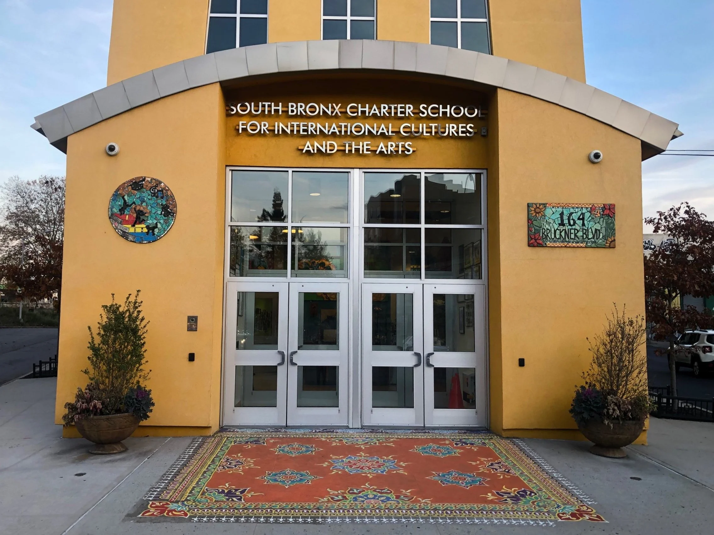 Exterior - welcoming all who enter into a transformative experience, mosaic signage.